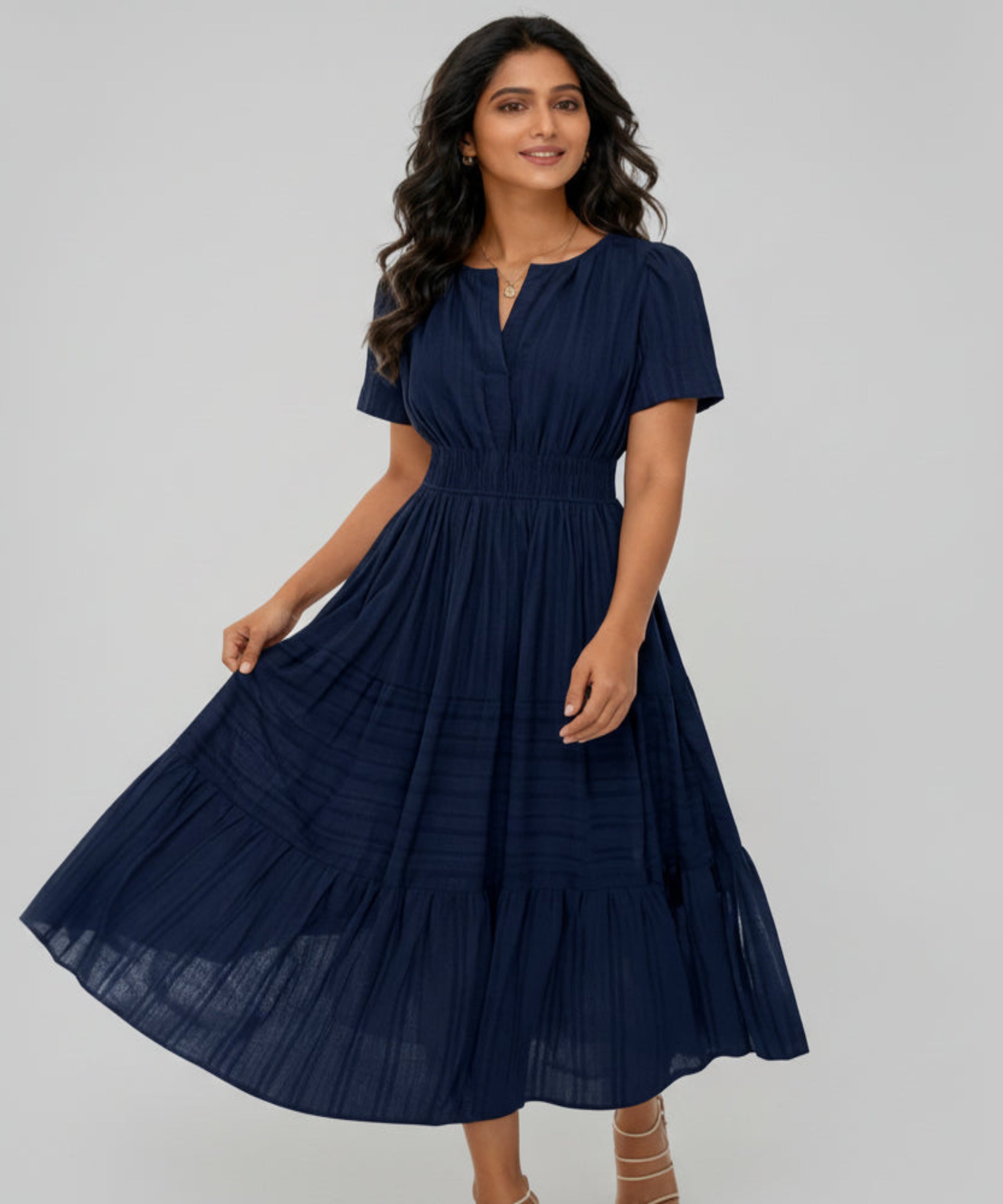 Woman wearing a navy blue dress on a white background