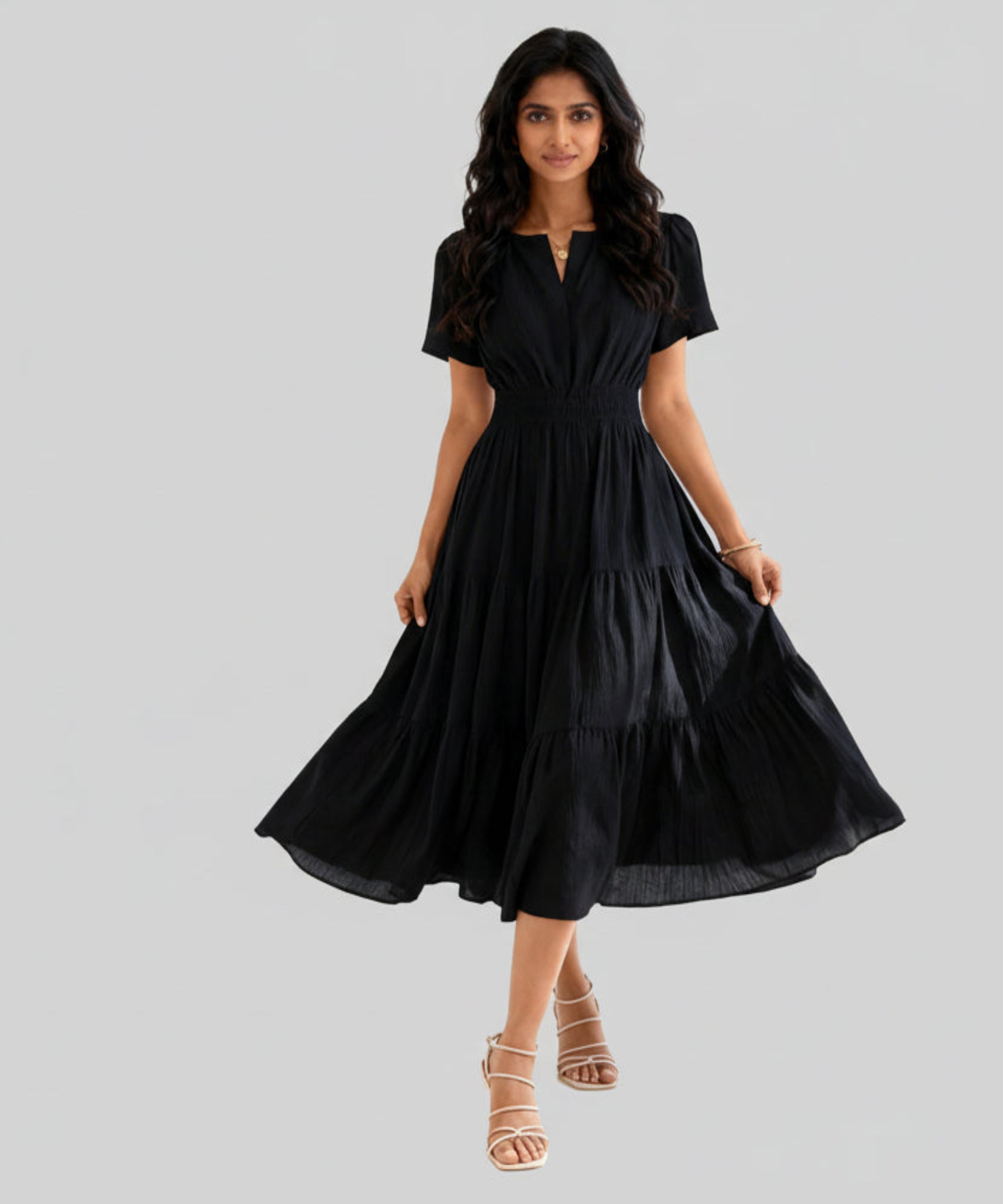 Woman wearing a black dress on a white background