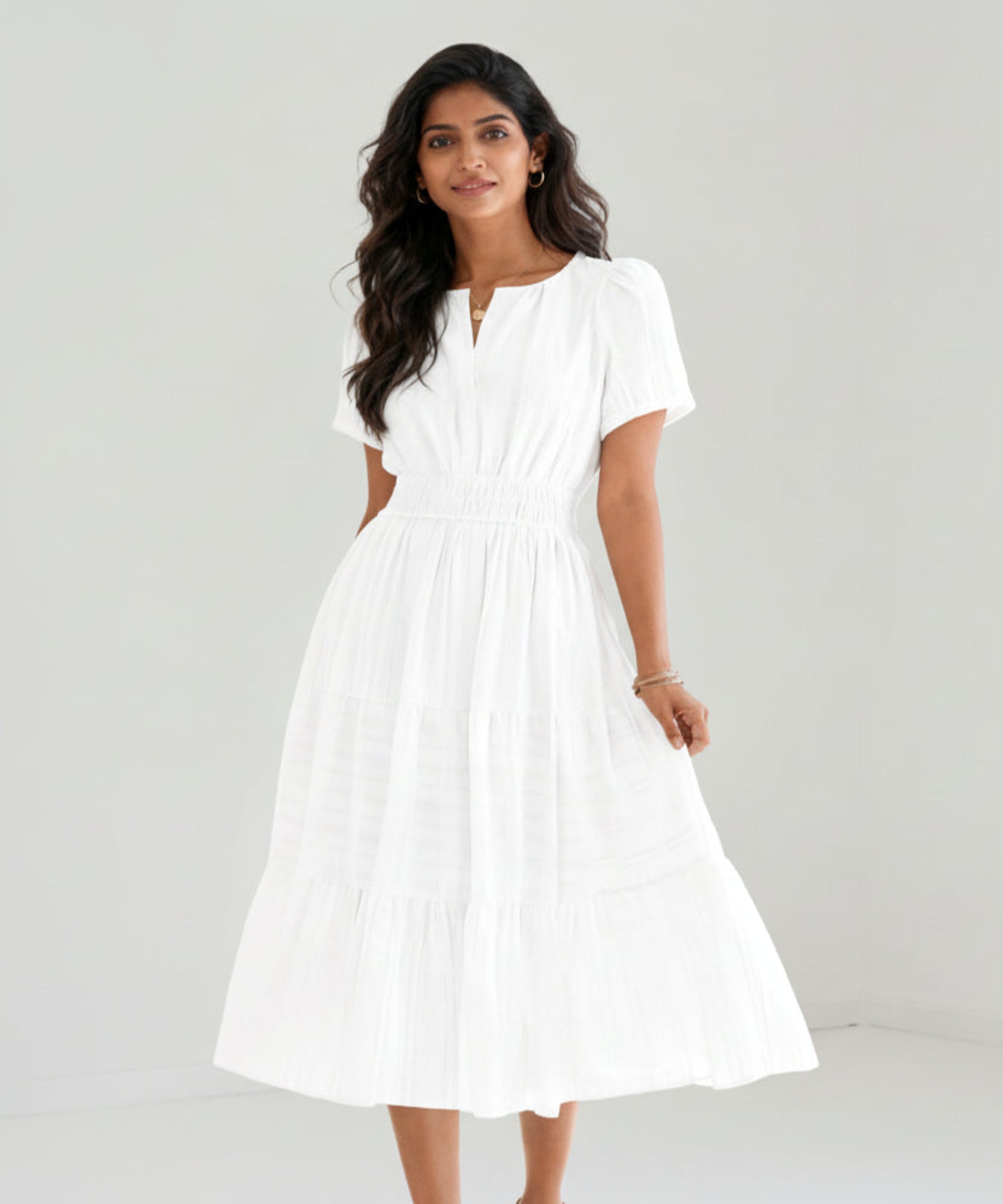 Woman wearing a white dress on a white background