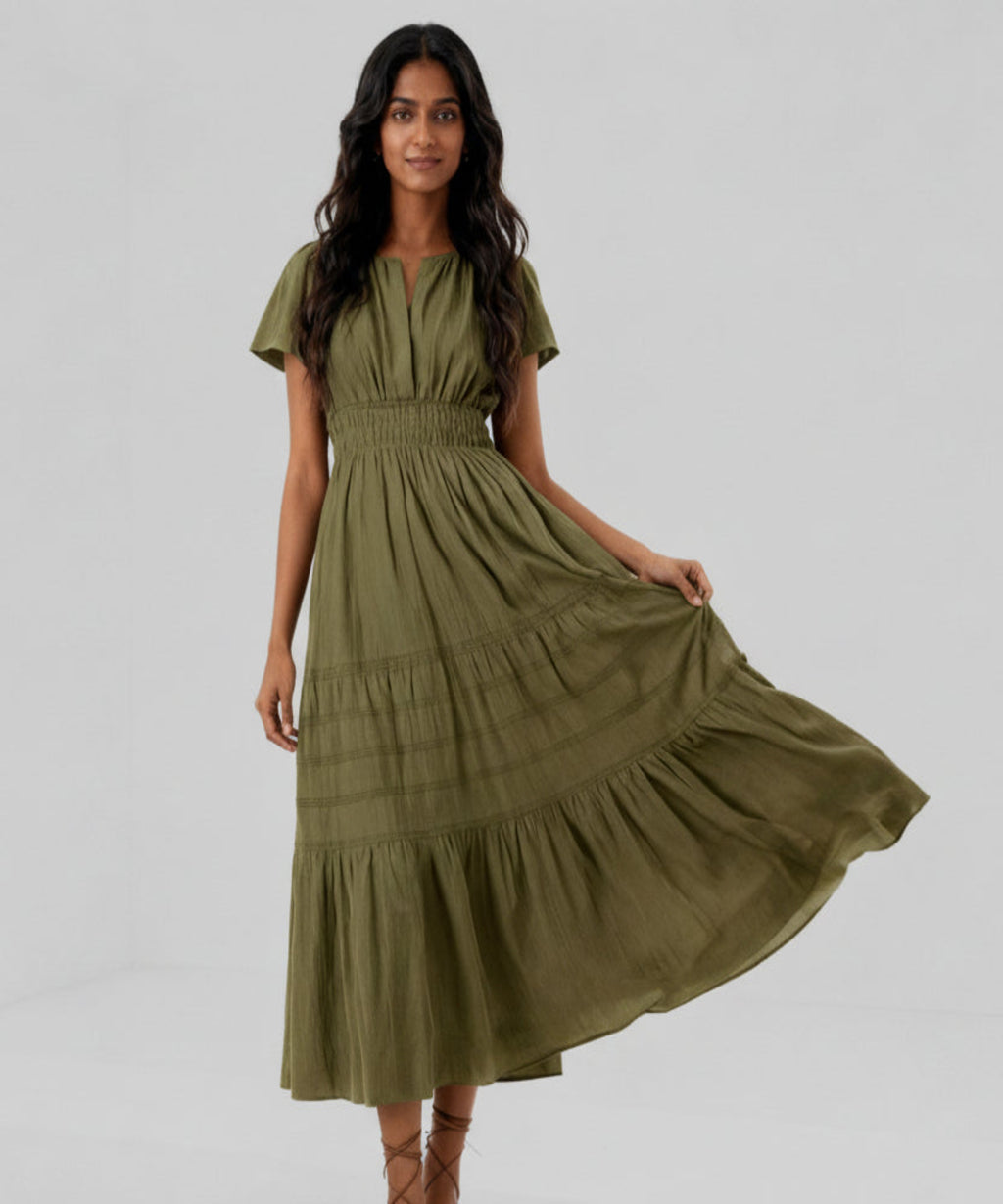 Woman wearing a green dress on a white background