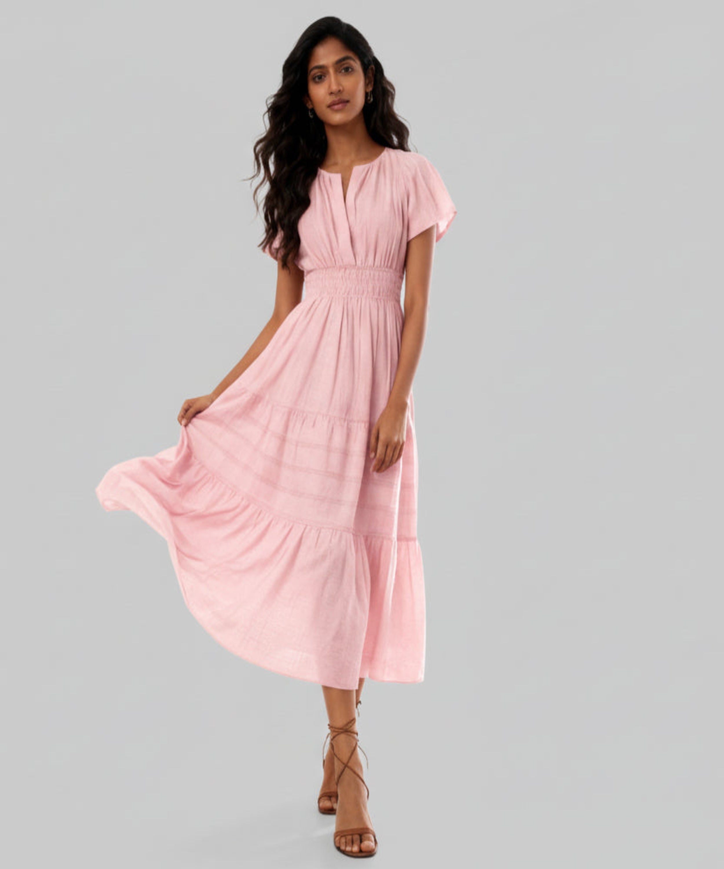 Woman wearing a pink dress on a white background