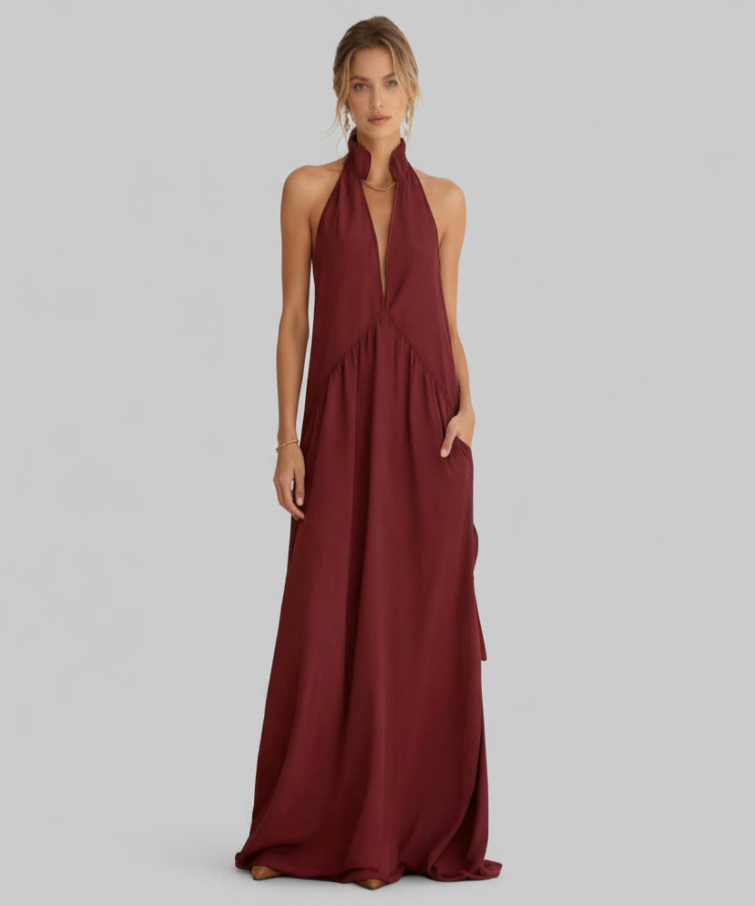 Maroon halter neck gown on a white background
