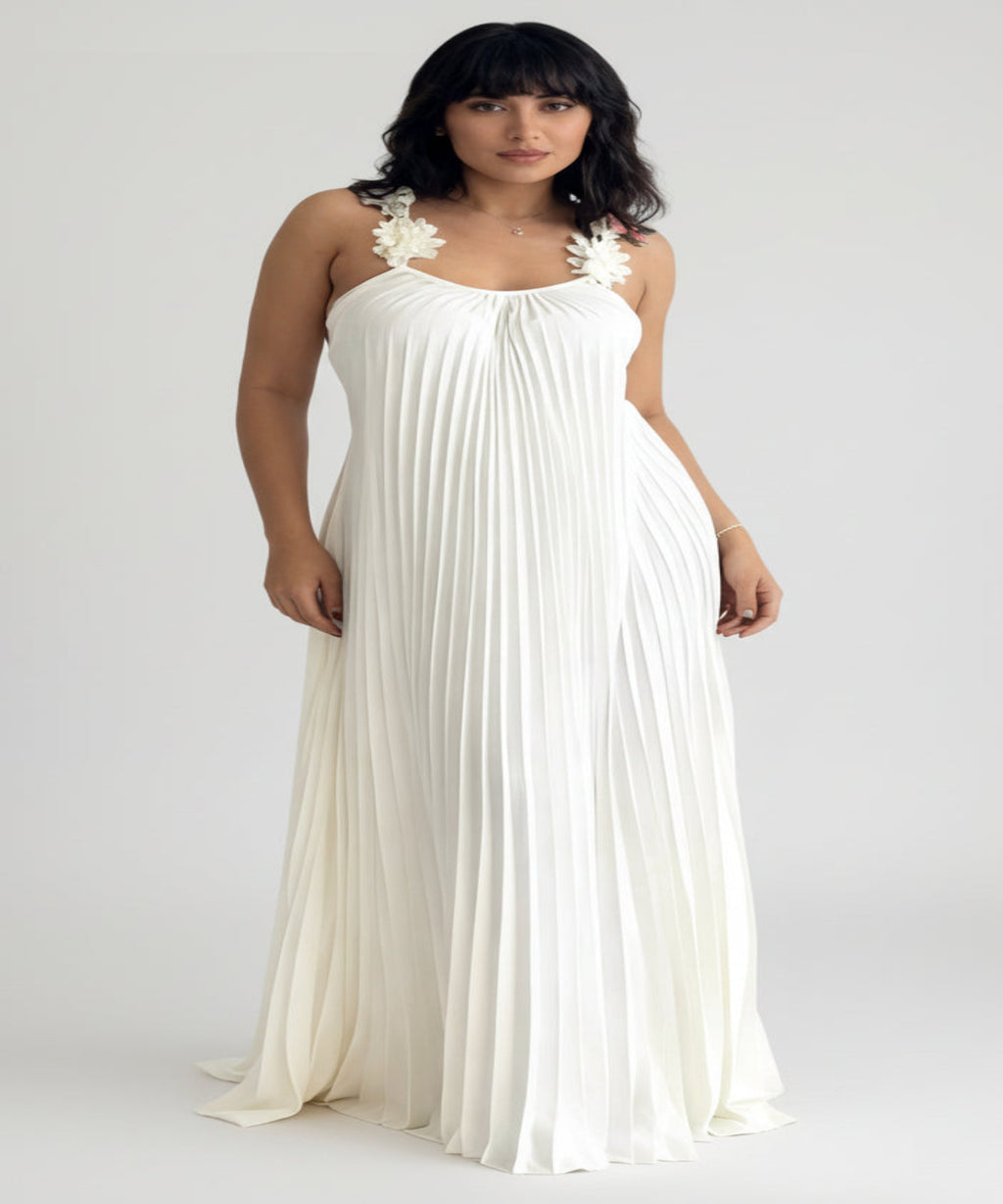 Woman wearing a white dress with floral straps on a white background