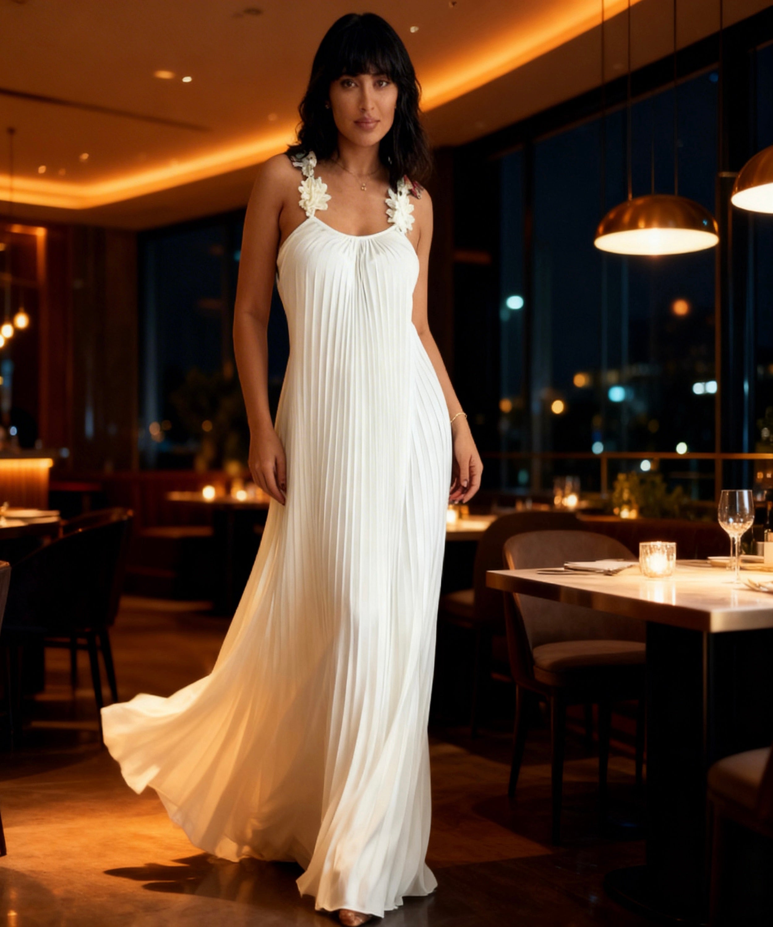 Woman in a white dress standing in a restaurant setting