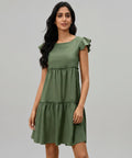 Woman wearing a green dress on a white background