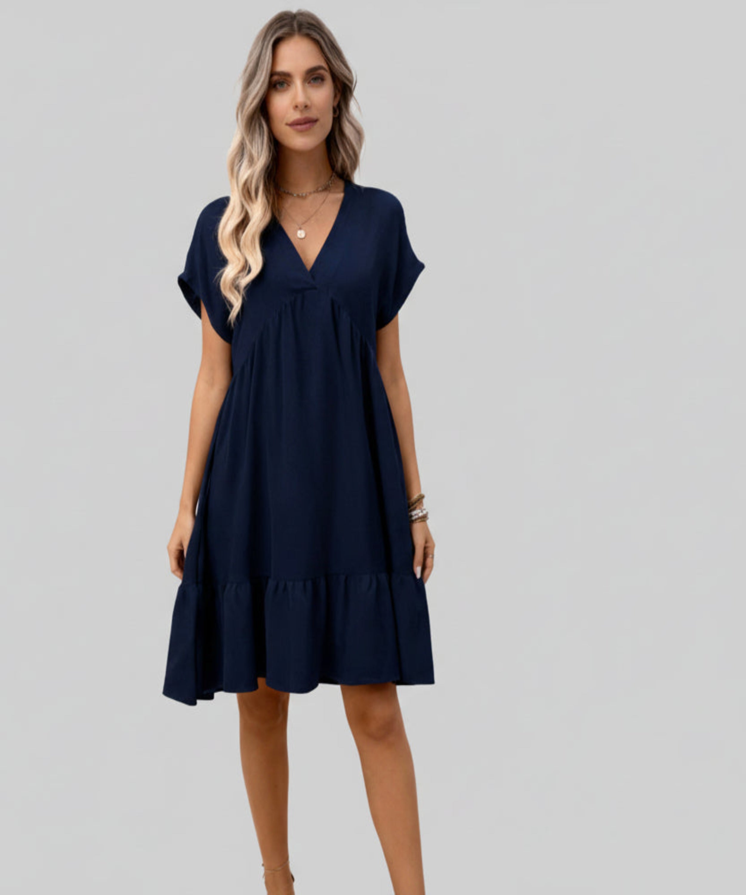 Woman wearing a navy blue dress on a white background