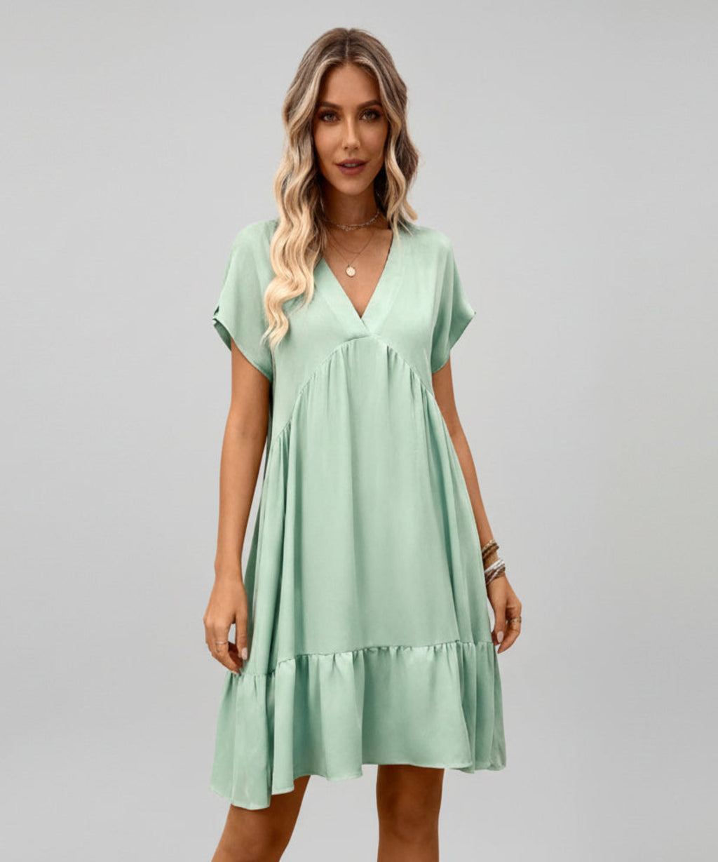 Woman wearing a light green dress on a white background