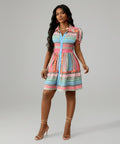 Woman wearing a colorful striped dress on a white background