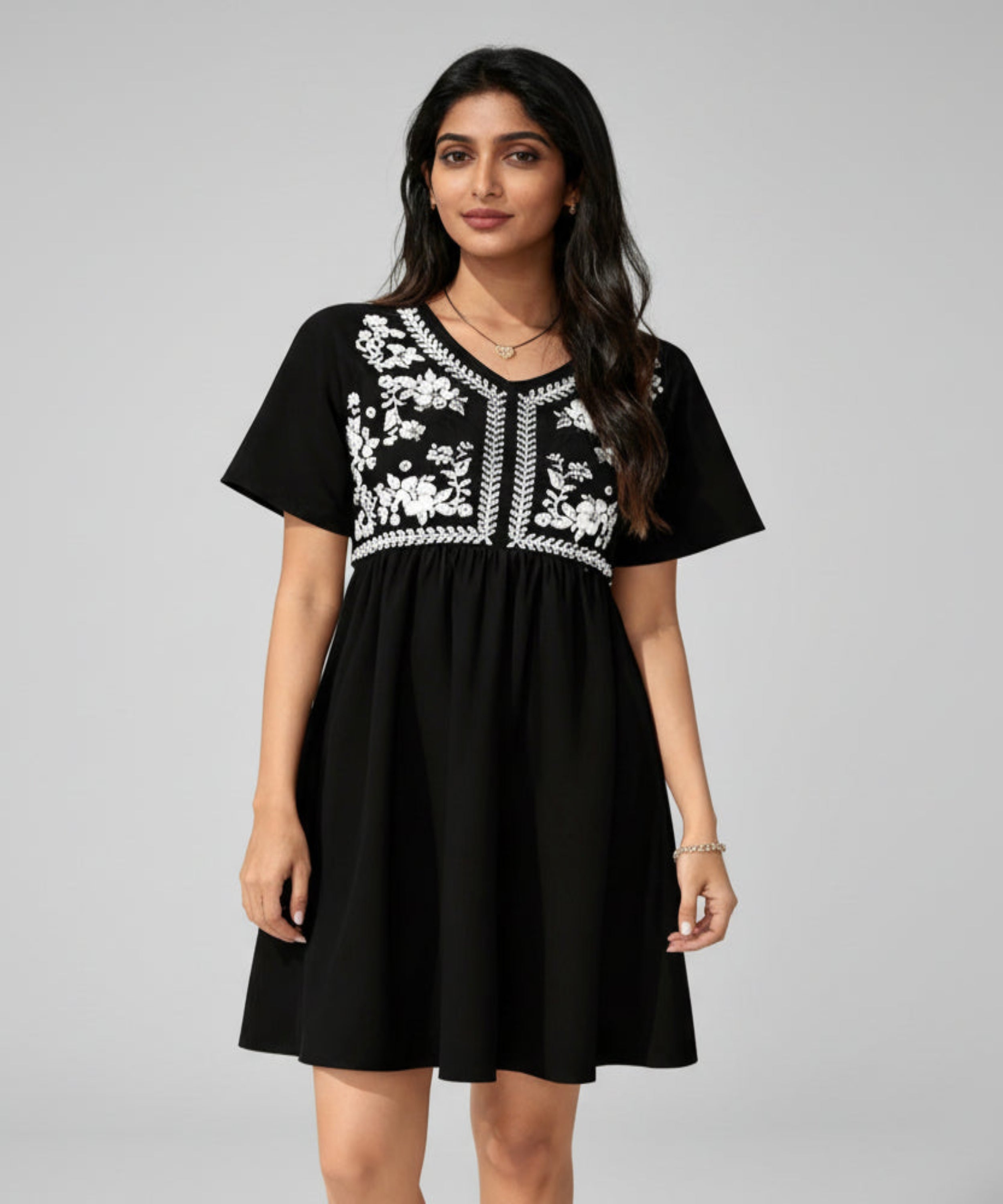 Black dress with white embroidery on a white background