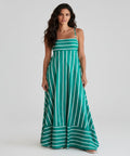 Woman wearing a green and white striped dress on a white background