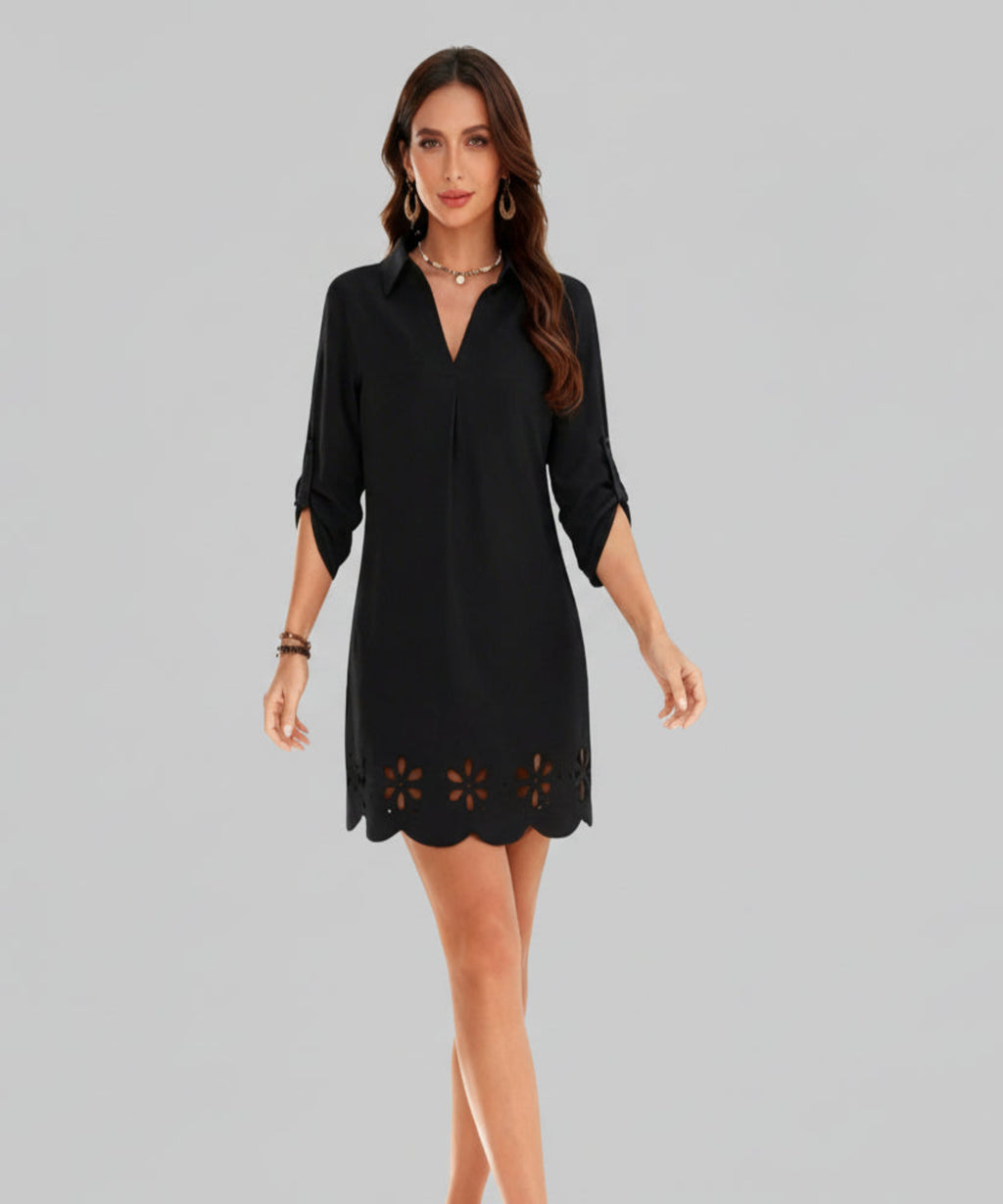 Woman wearing a black dress with cut-out details on a white background