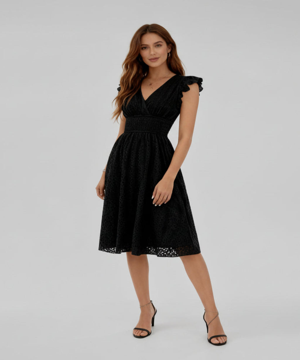 Woman wearing a black dress on a white background