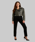 Woman wearing a black leather jacket and black pants on a white background