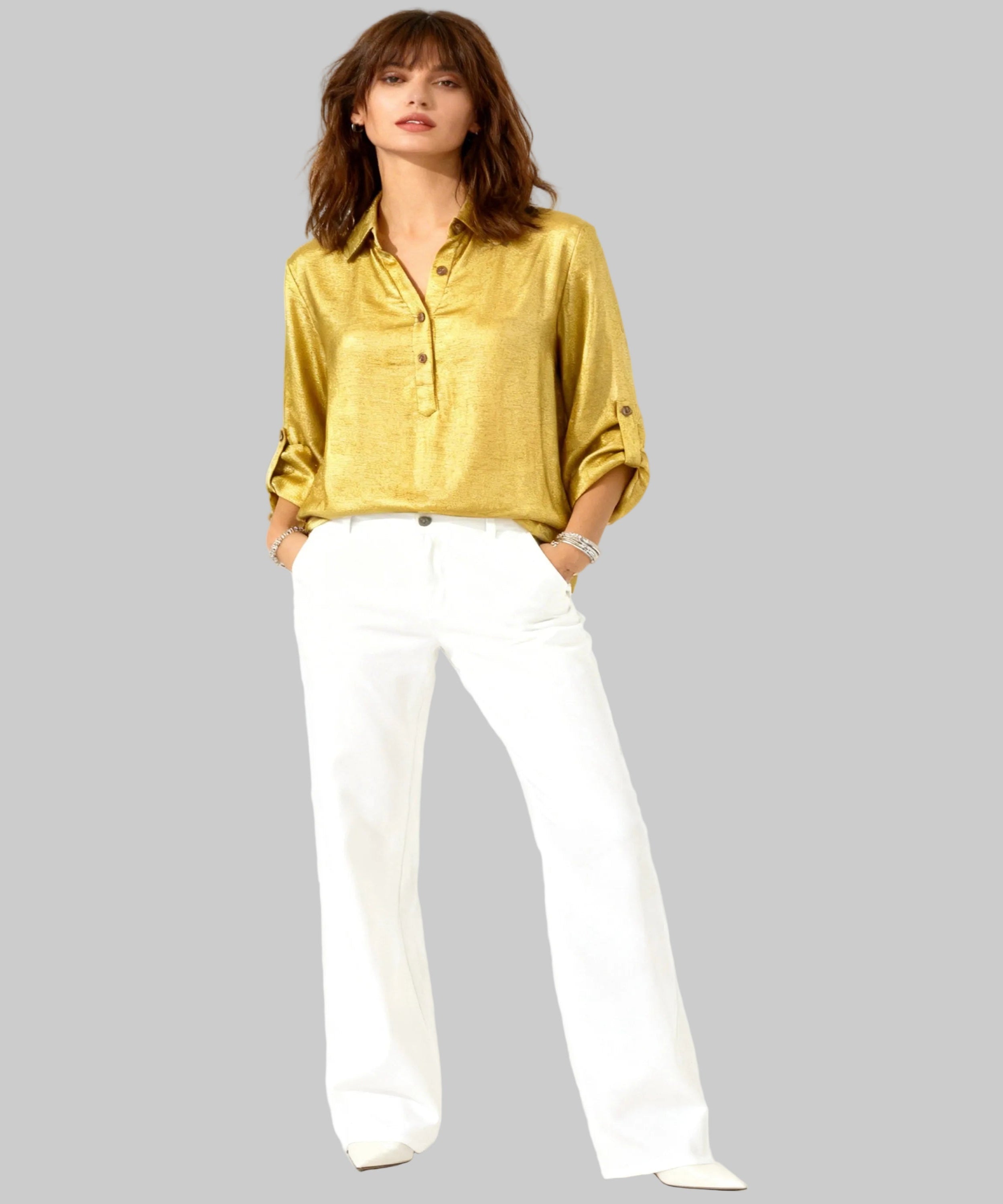 Woman wearing a yellow blouse and white pants on a white background