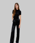 Woman wearing a black outfit on a white background