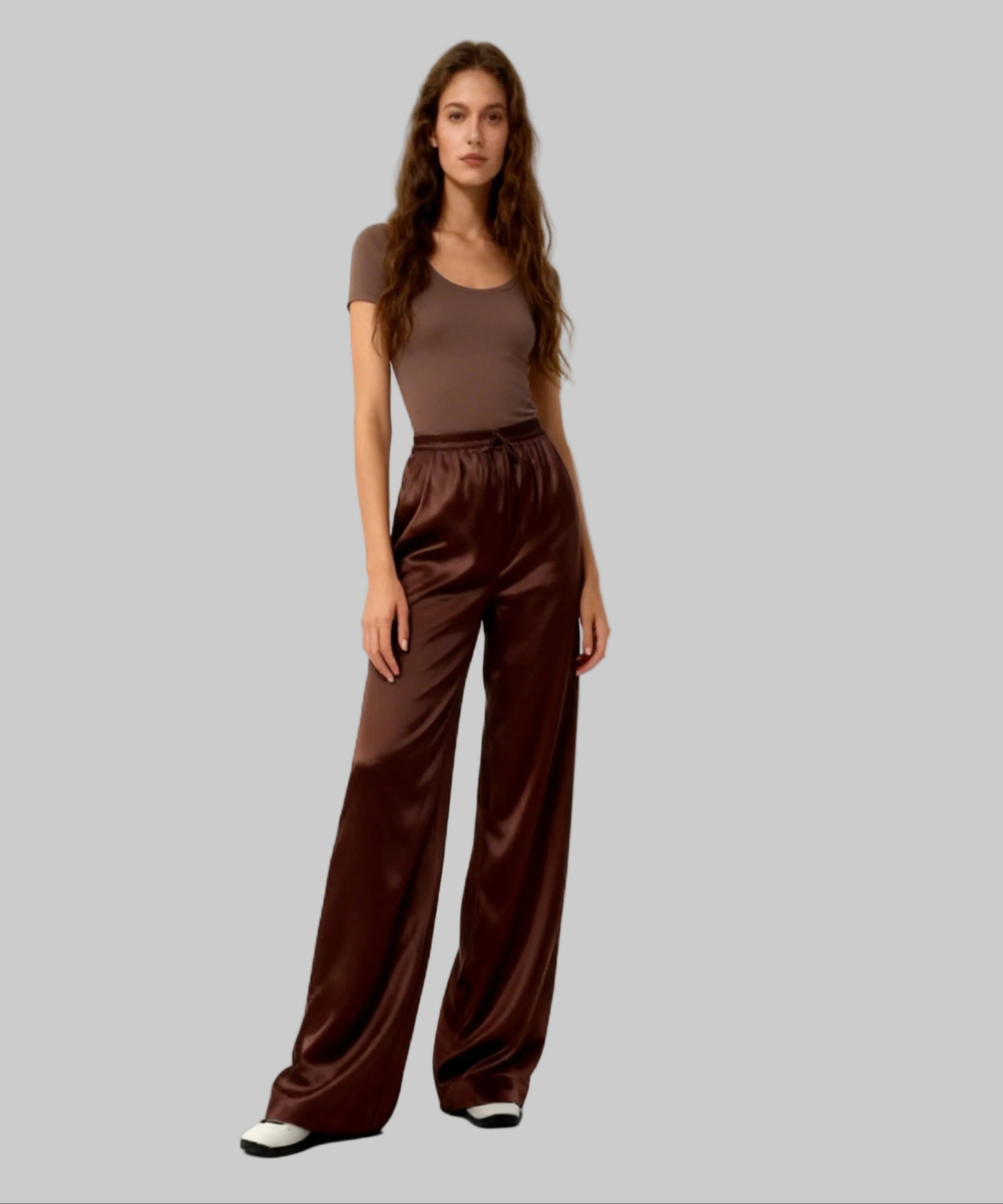 Woman wearing a brown outfit with wide-leg pants on a white background