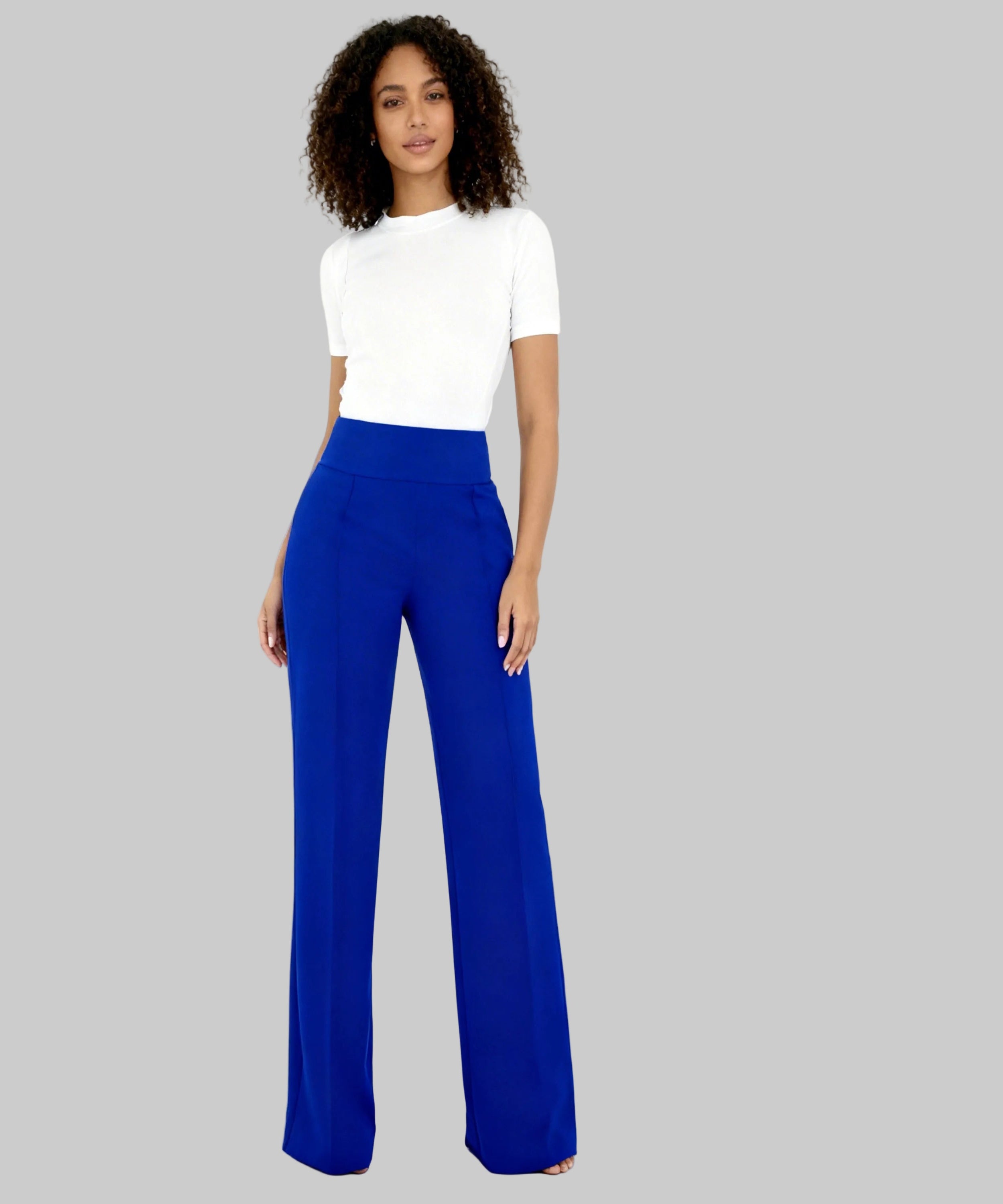 Woman wearing a white top and blue pants on a white background