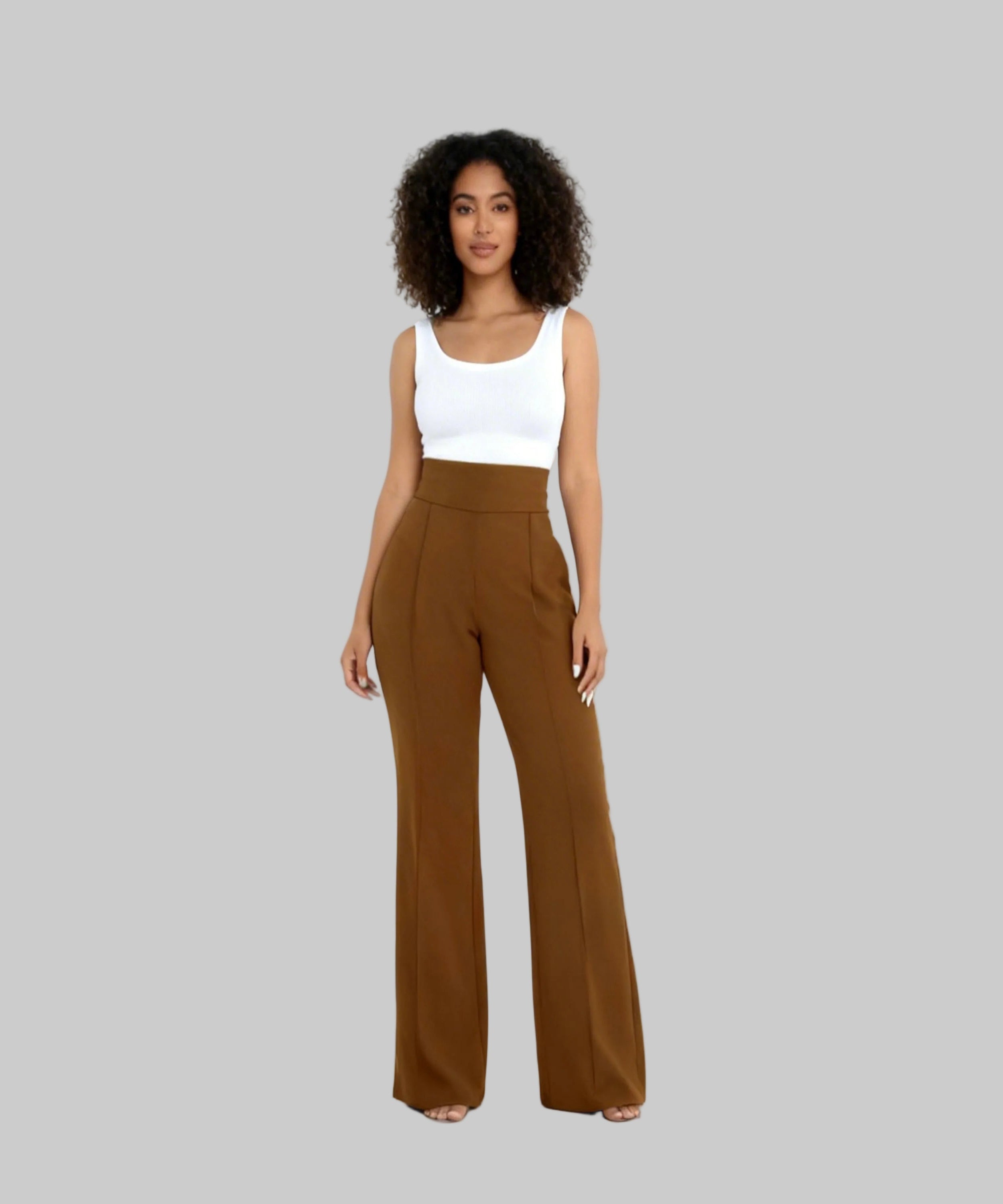 Woman wearing a white top and brown wide-leg pants on a white background