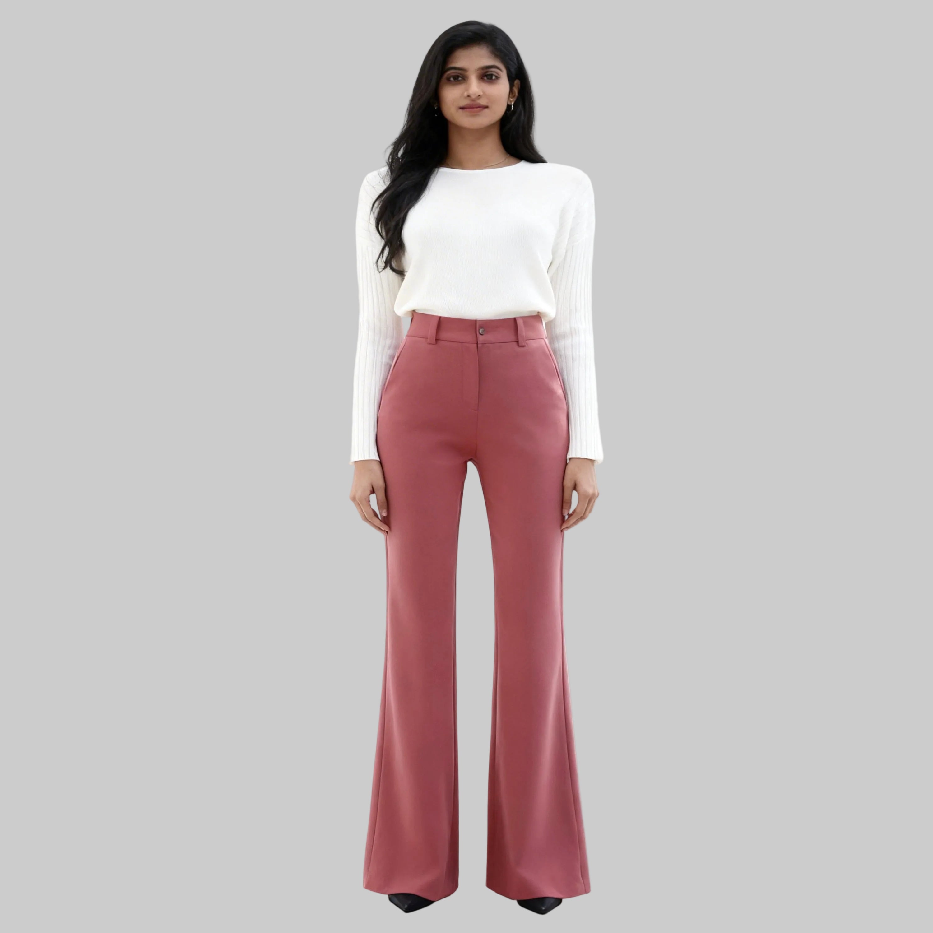 Asian women dressed on a pink trousers sits on a white background