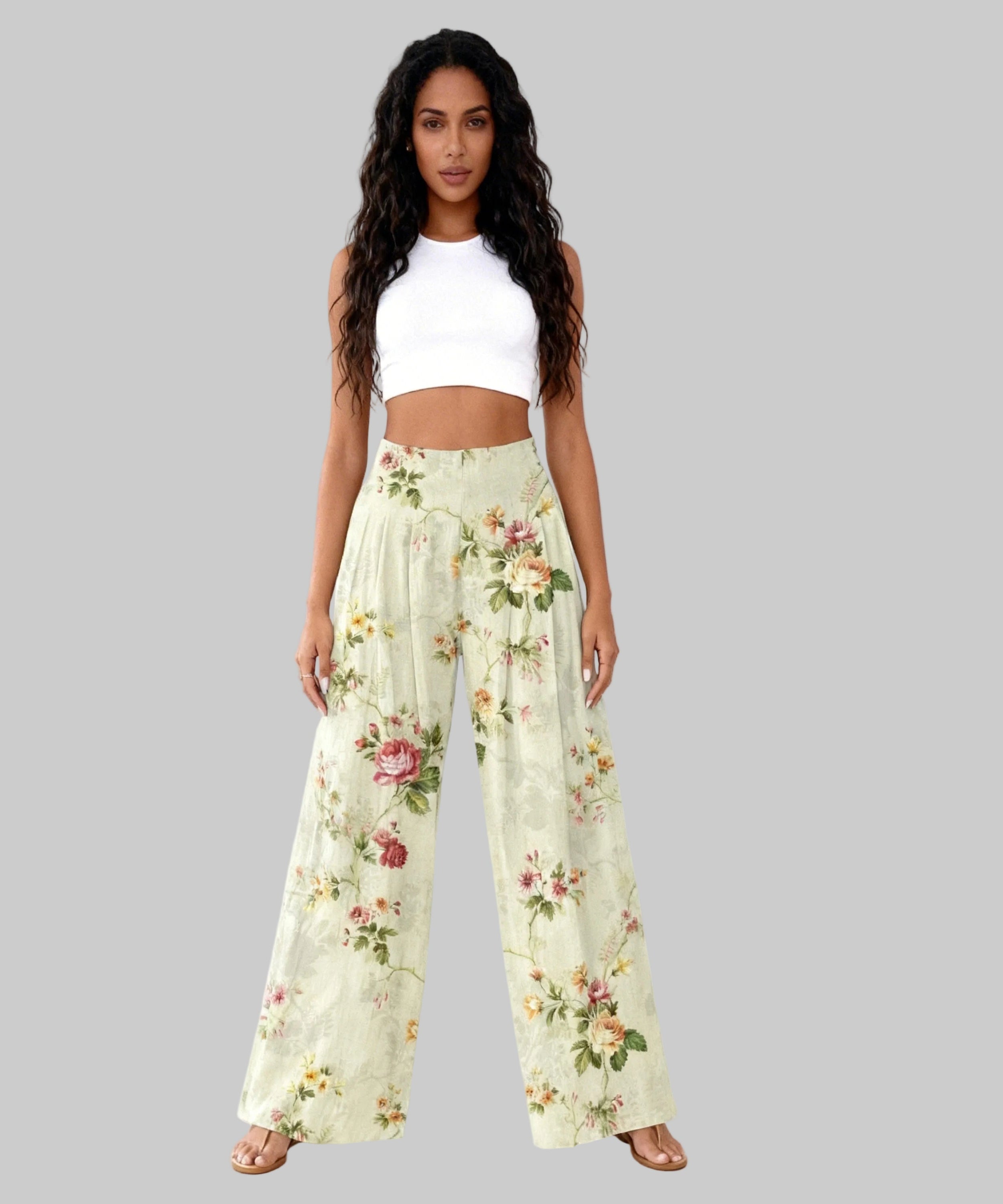 Woman wearing a white top and floral pants on a white background