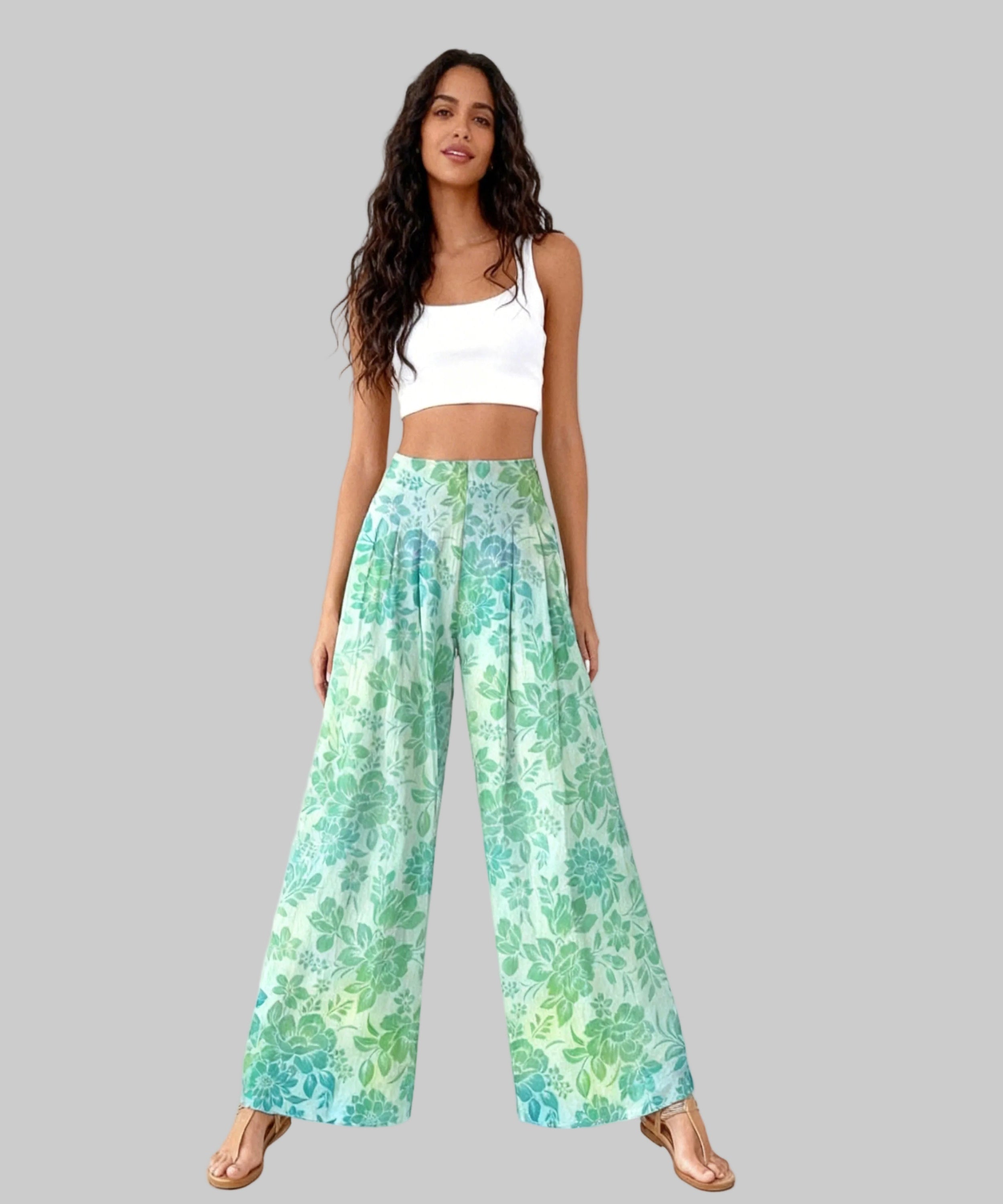 Woman wearing a white top and floral pants on a white background