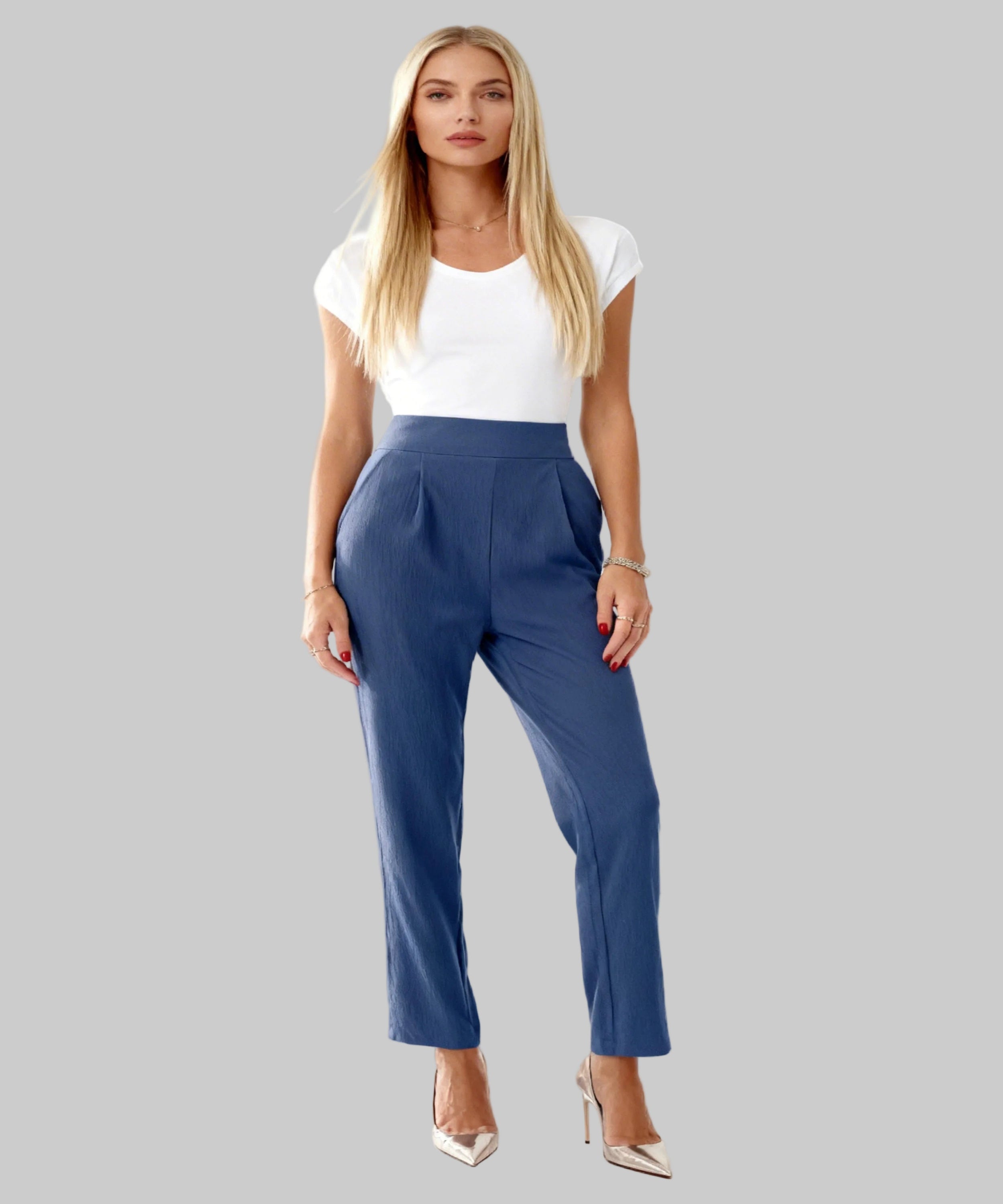 white girl dressed in a navy trousers sits on a white background