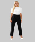 Woman wearing a white top and black pants on a white background