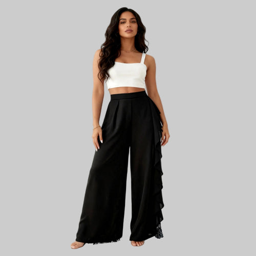 Woman wearing a white top and black wide-leg pants on a white background