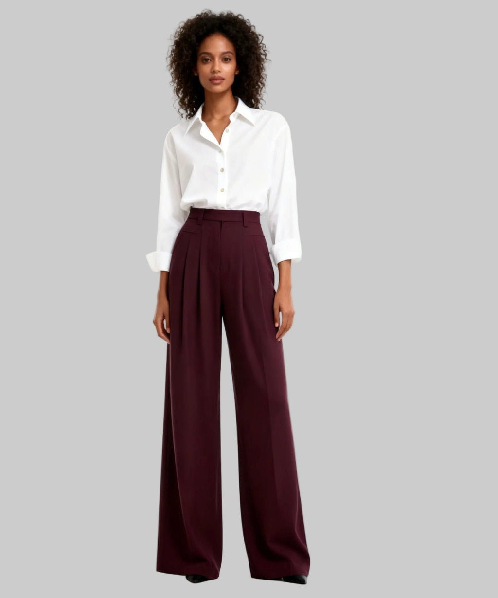 Woman wearing a white shirt and maroon wide-leg pants on a white background