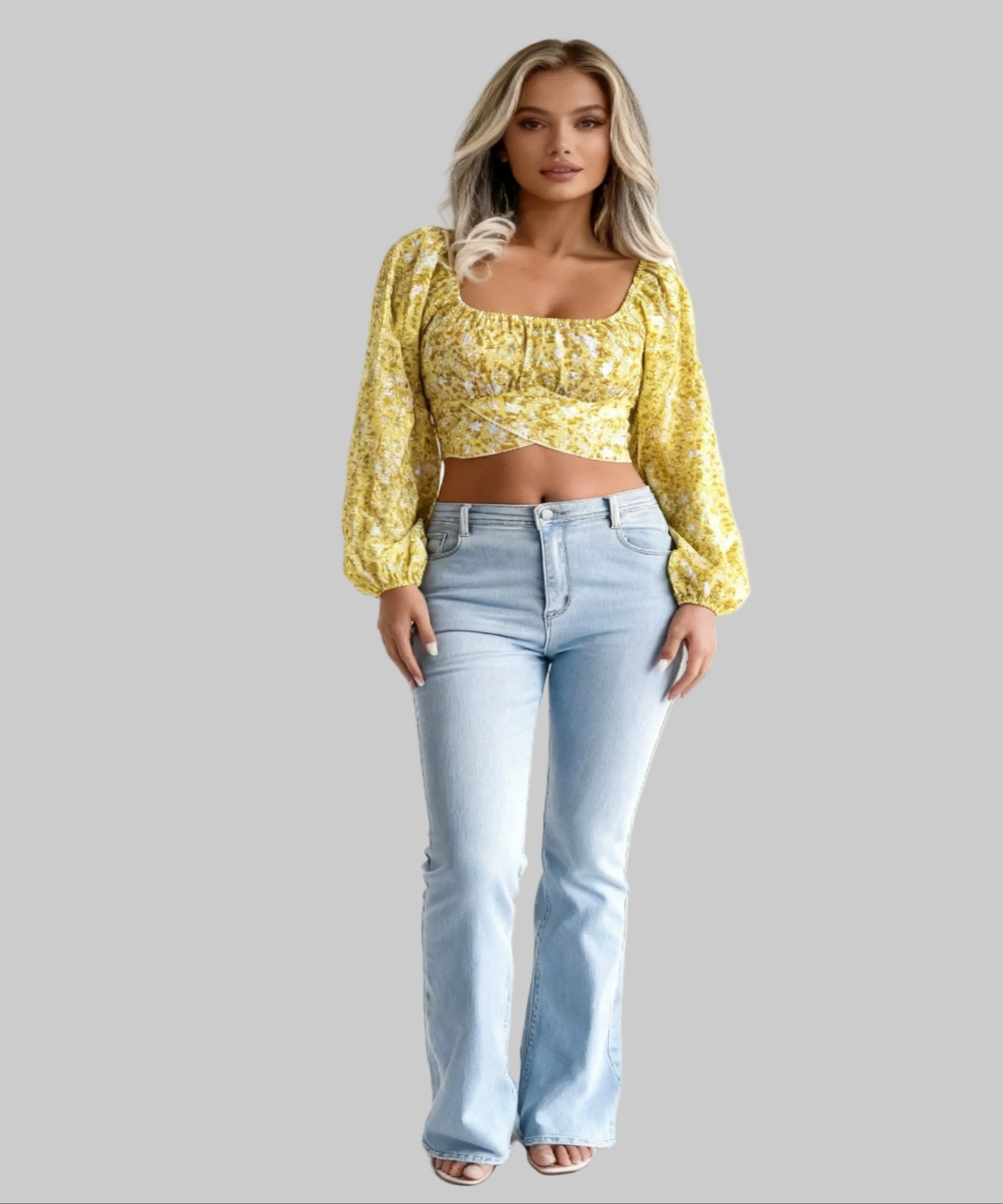 Woman wearing a yellow floral blouse and light blue jeans on a white background