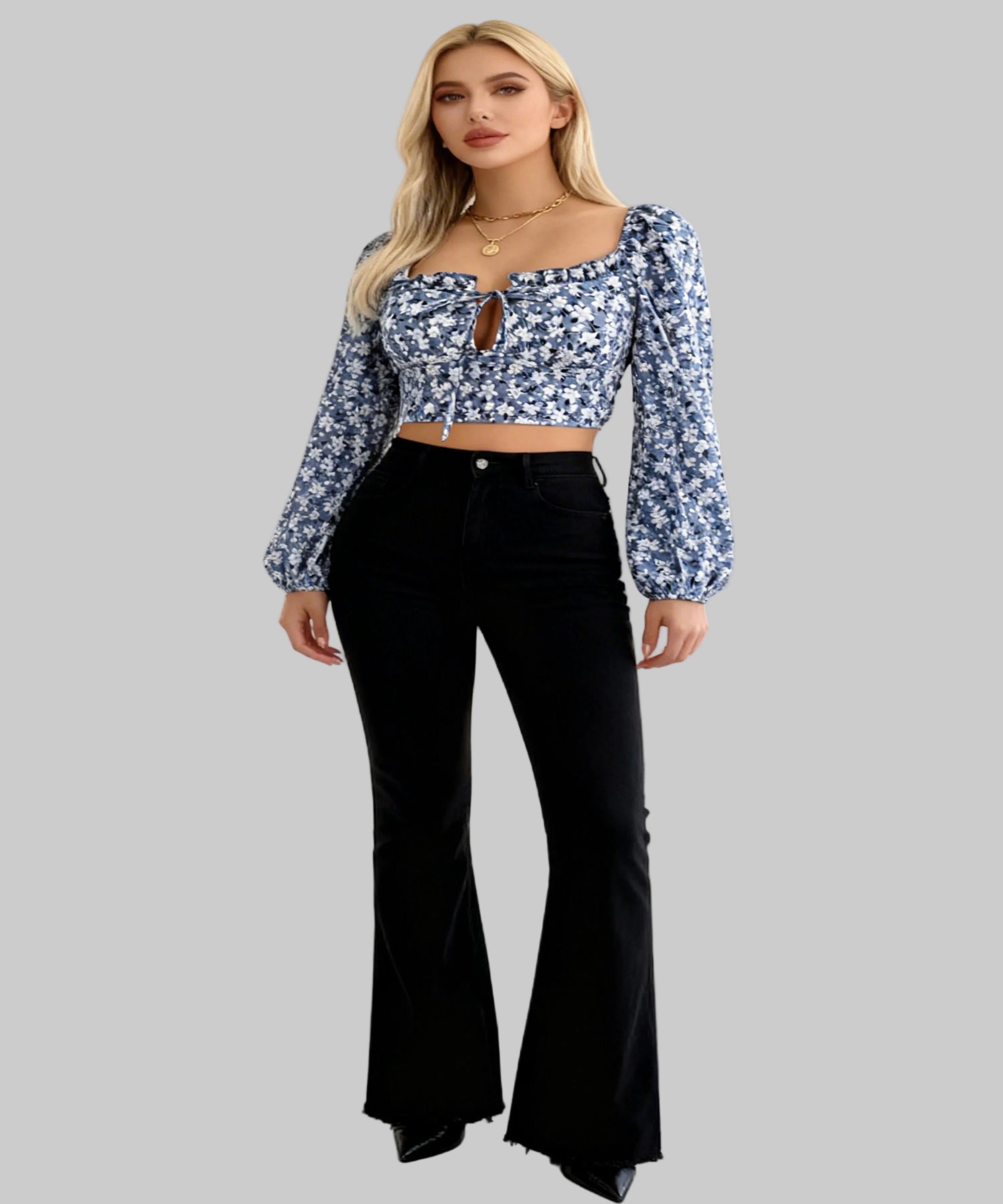 Woman wearing a floral blouse and black bell-bottom pants on a white background