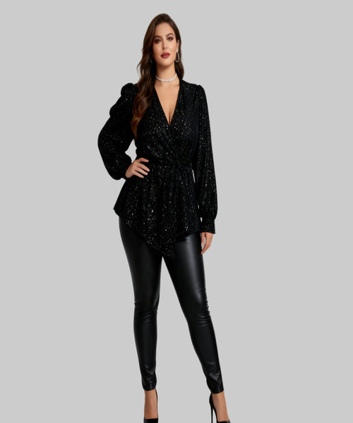 Woman wearing a black sequin top and leather pants on a white background