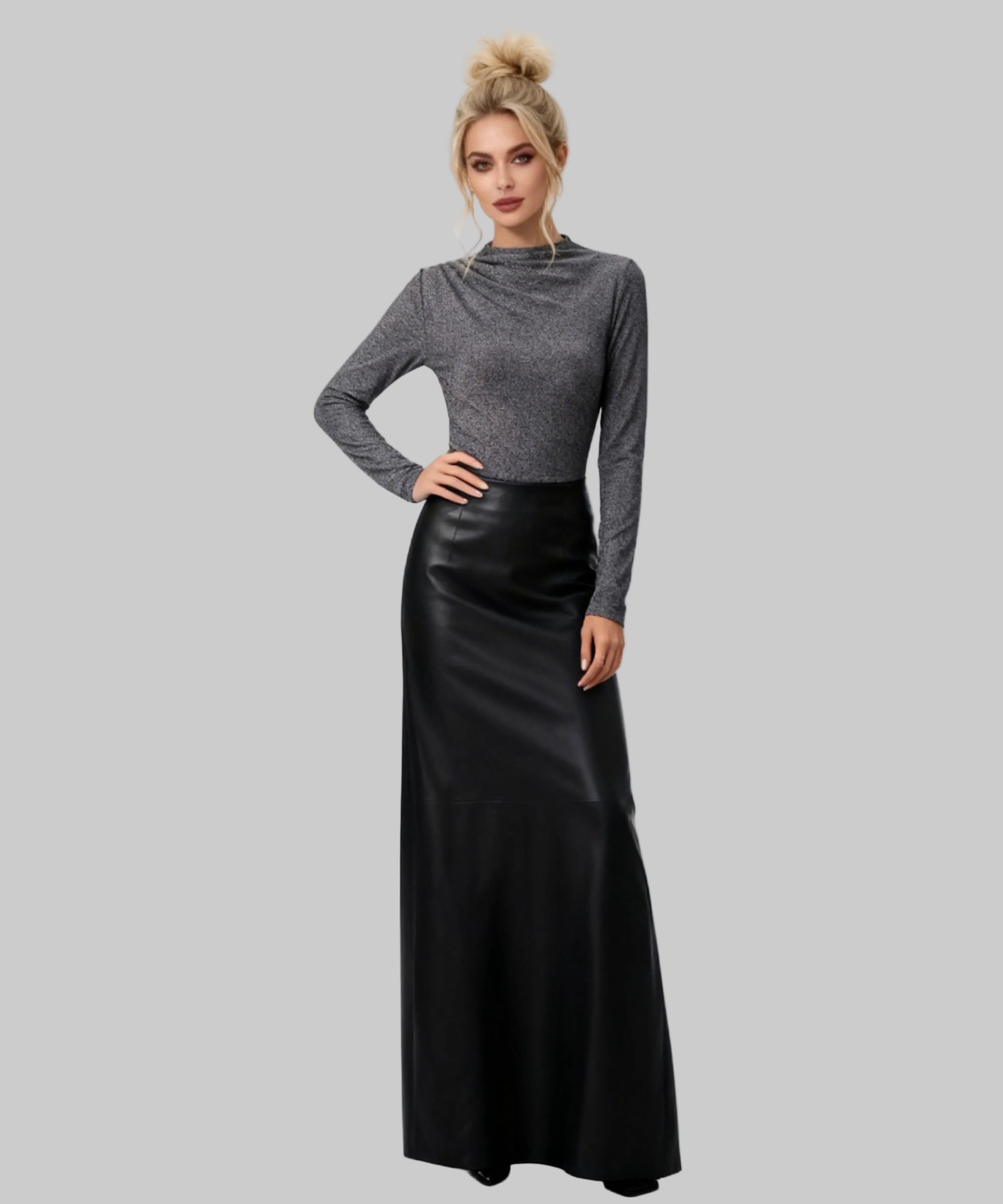 Woman wearing a gray long-sleeve top and black leather skirt on a white background