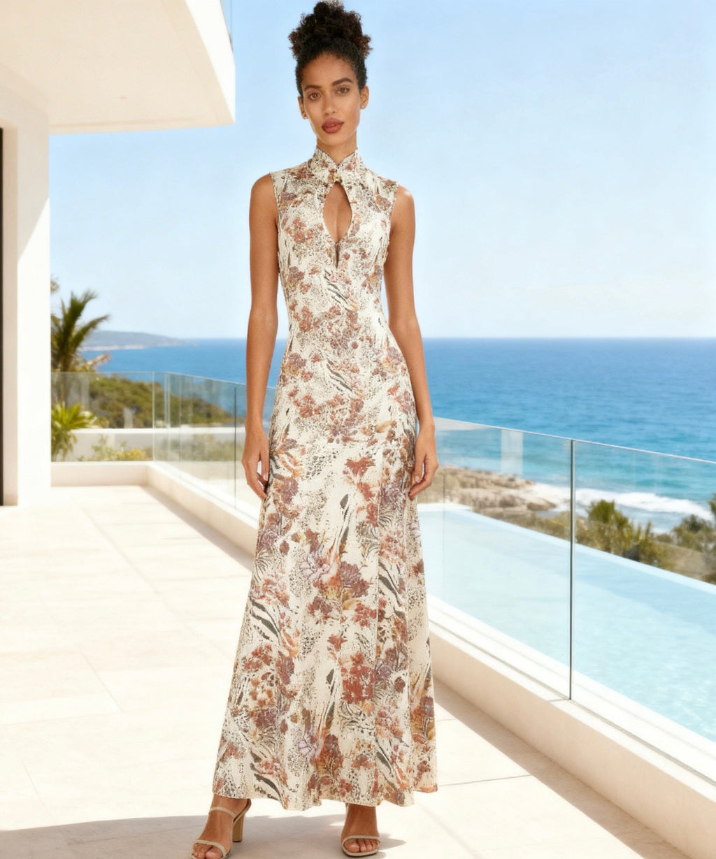 Woman in a floral dress standing in front of a scenic ocean view.
