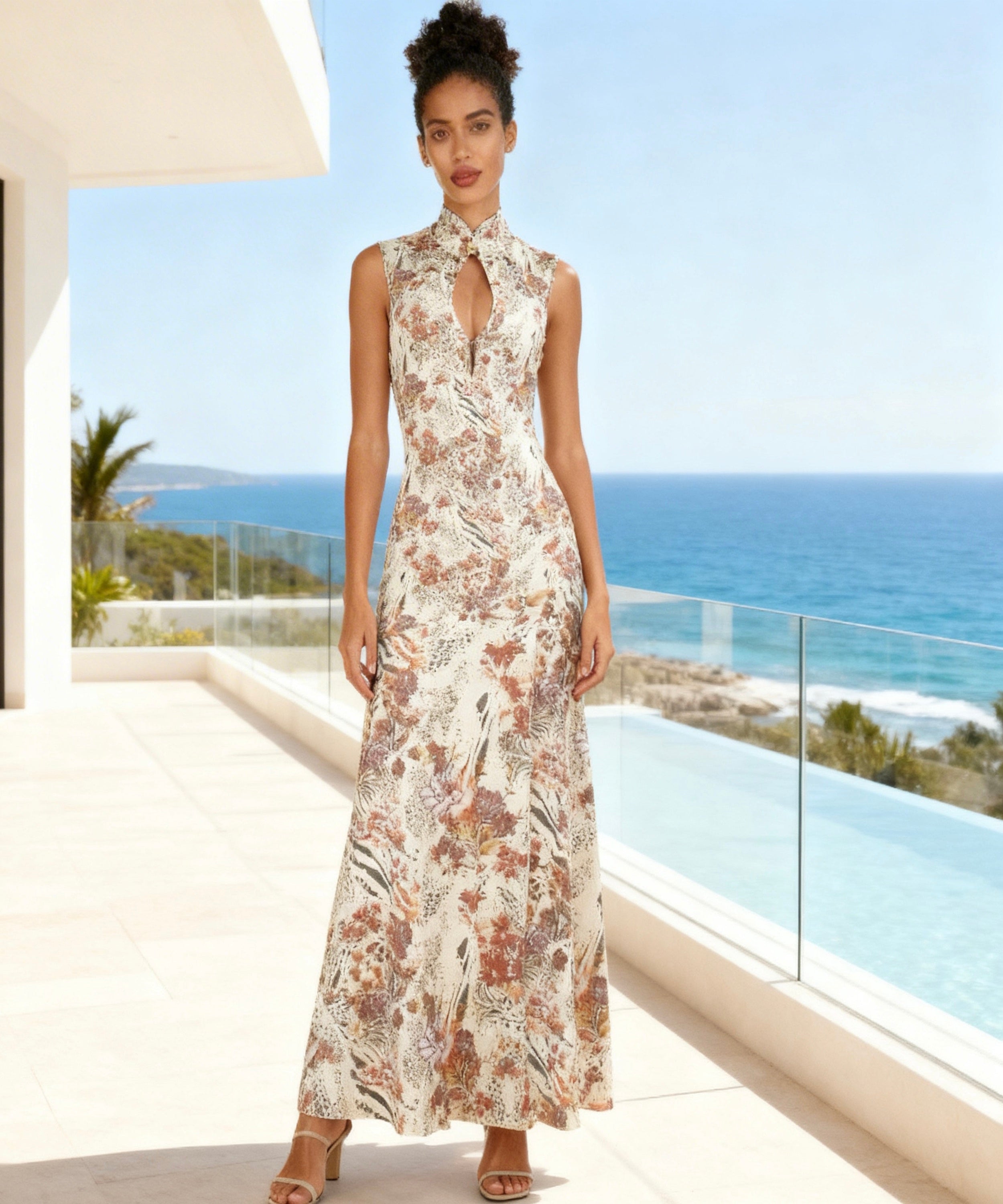 Woman in a floral dress standing in front of a scenic ocean view.