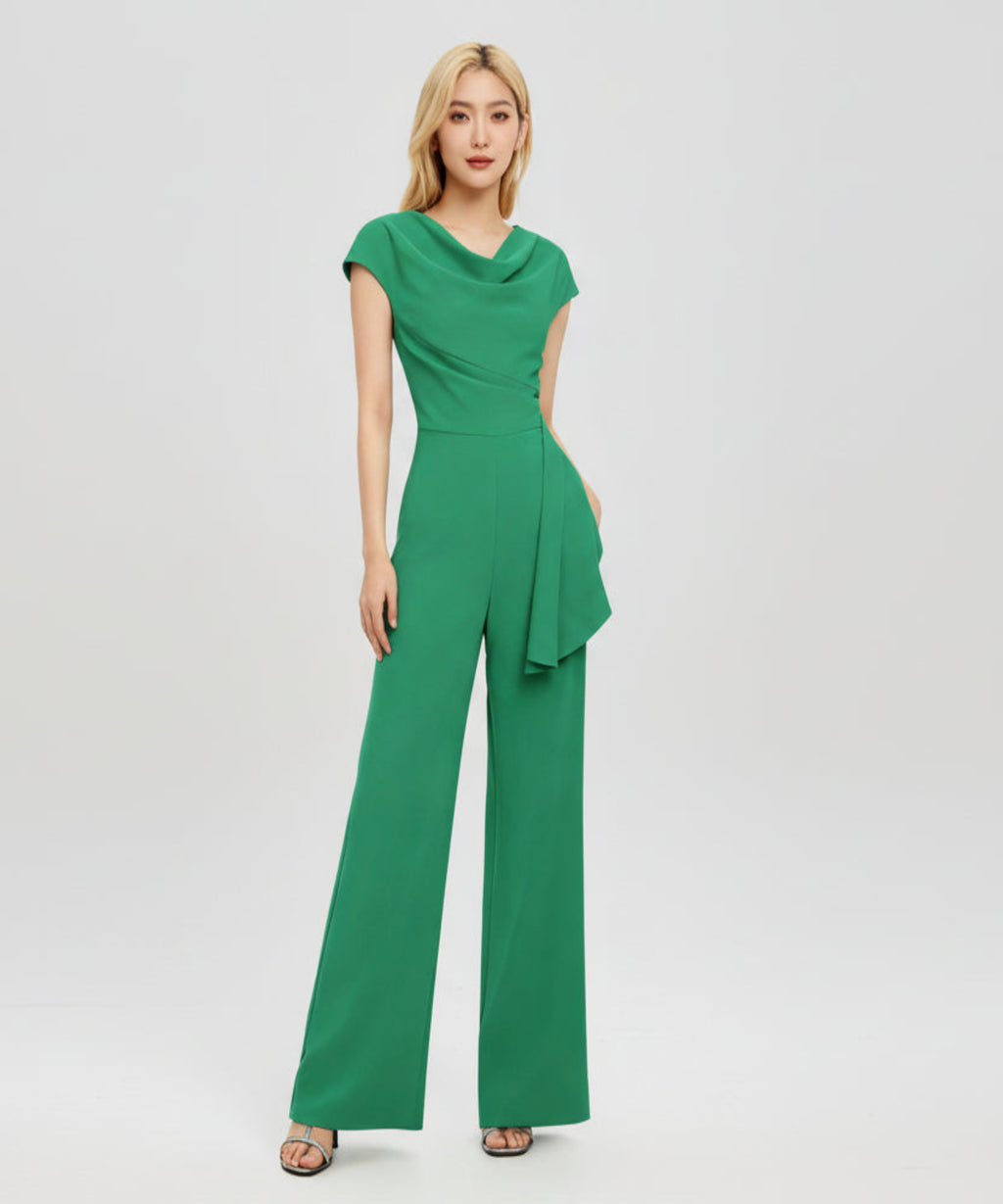 Woman wearing a green jumpsuit on a white background