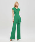 Woman wearing a green jumpsuit on a white background