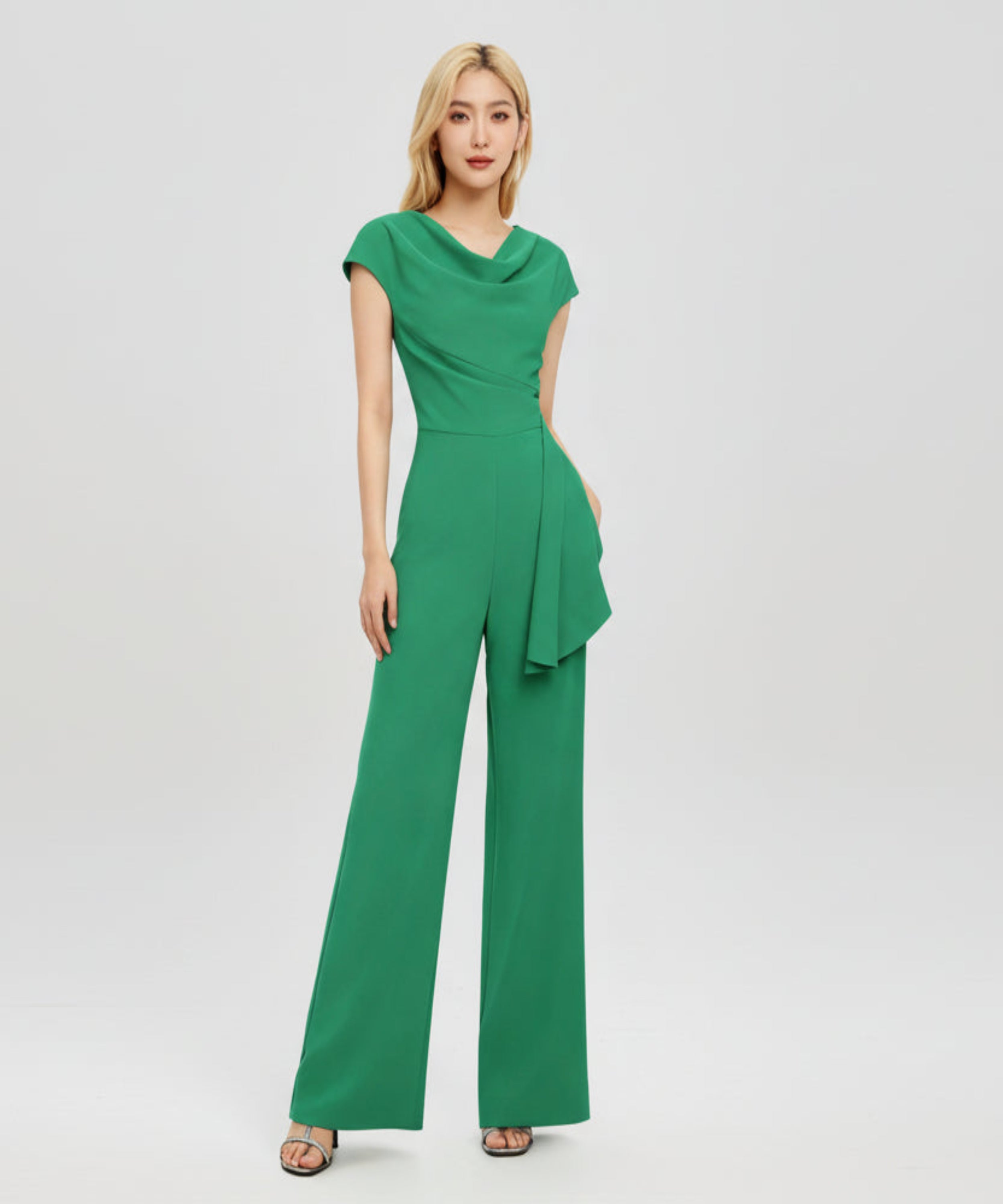 Woman wearing a green jumpsuit on a white background