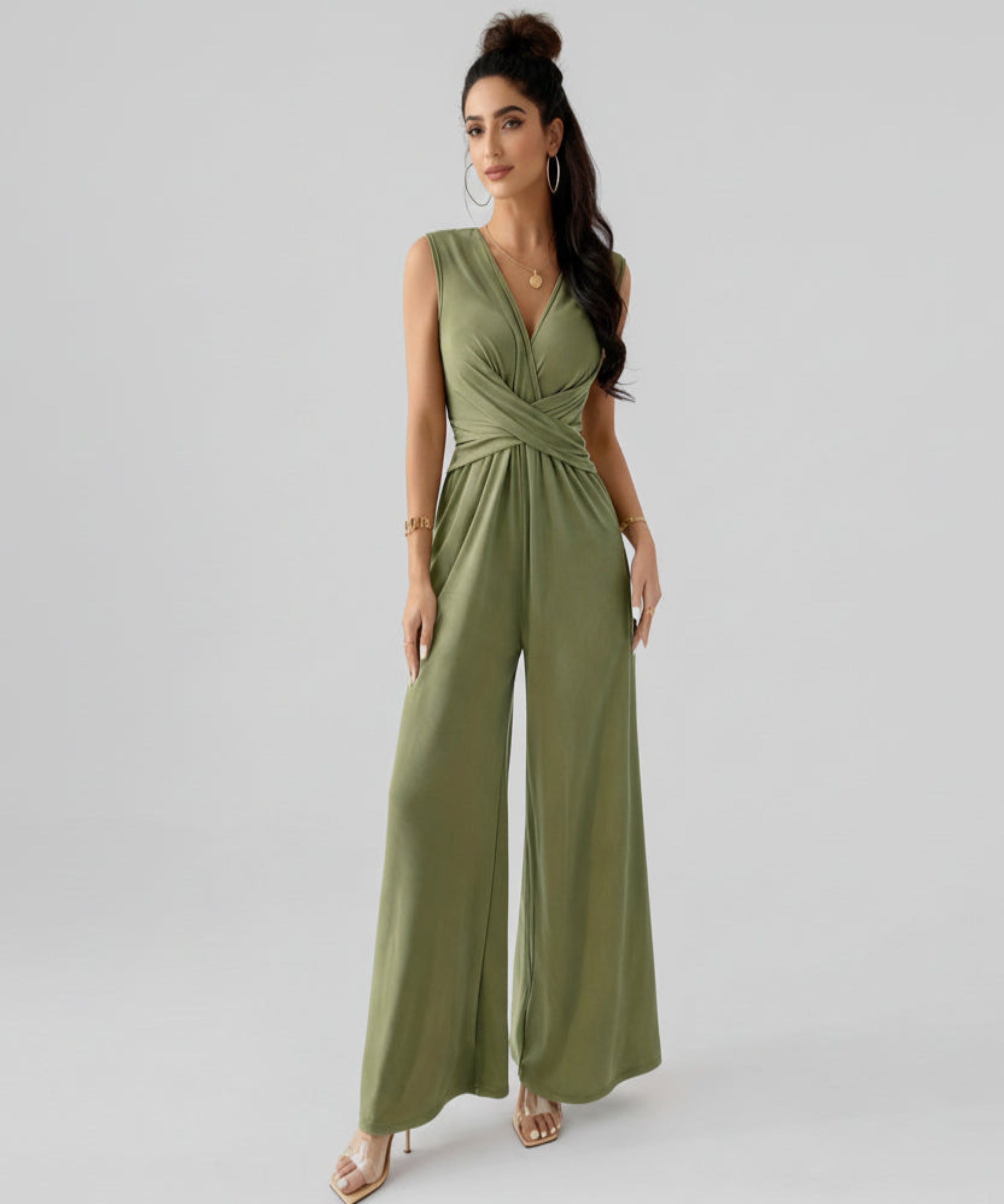 Woman wearing a green jumpsuit on a white background