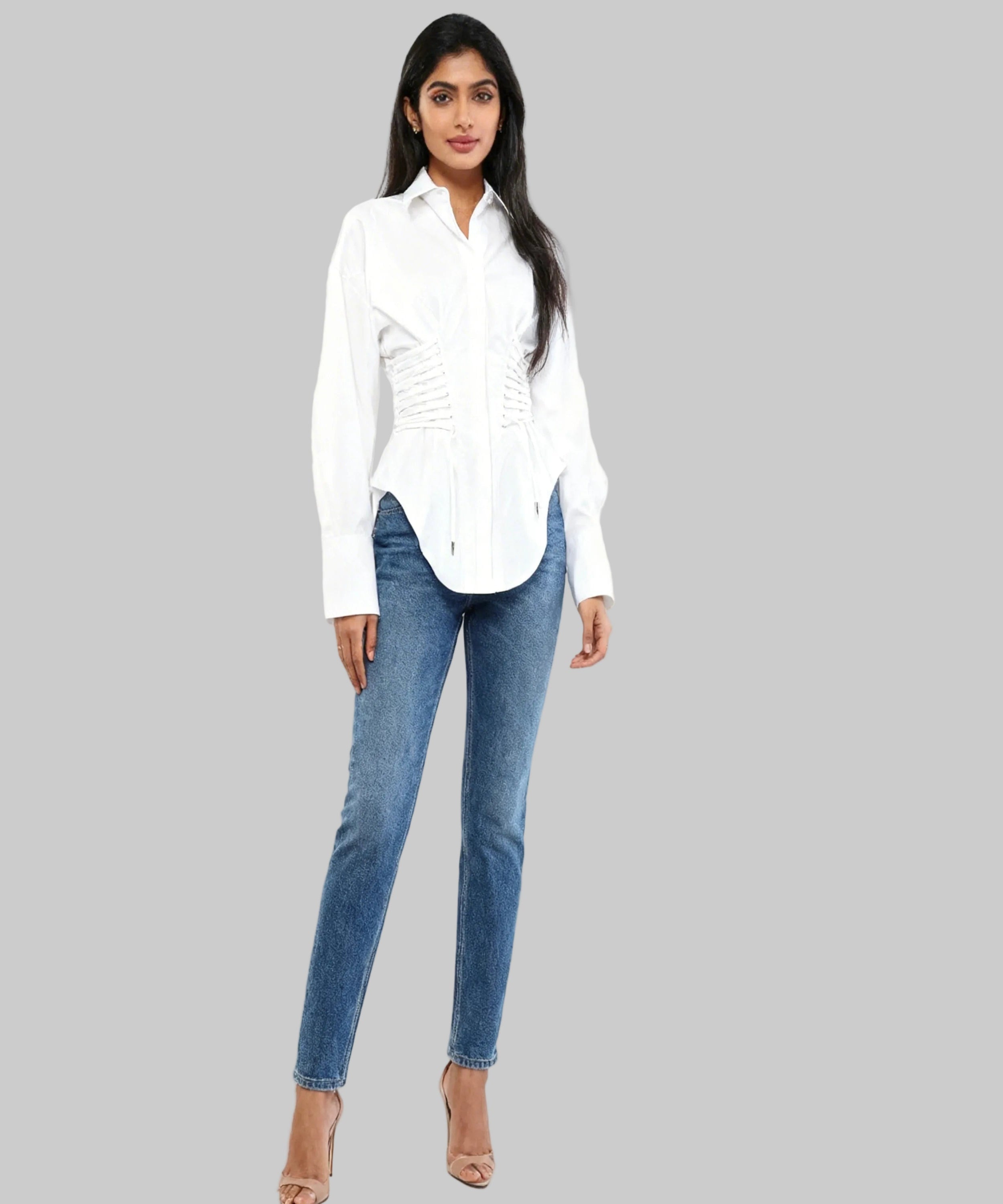 Woman wearing a white shirt and blue jeans on a white background