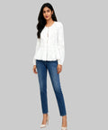 Woman wearing a white blouse and blue jeans on a white background