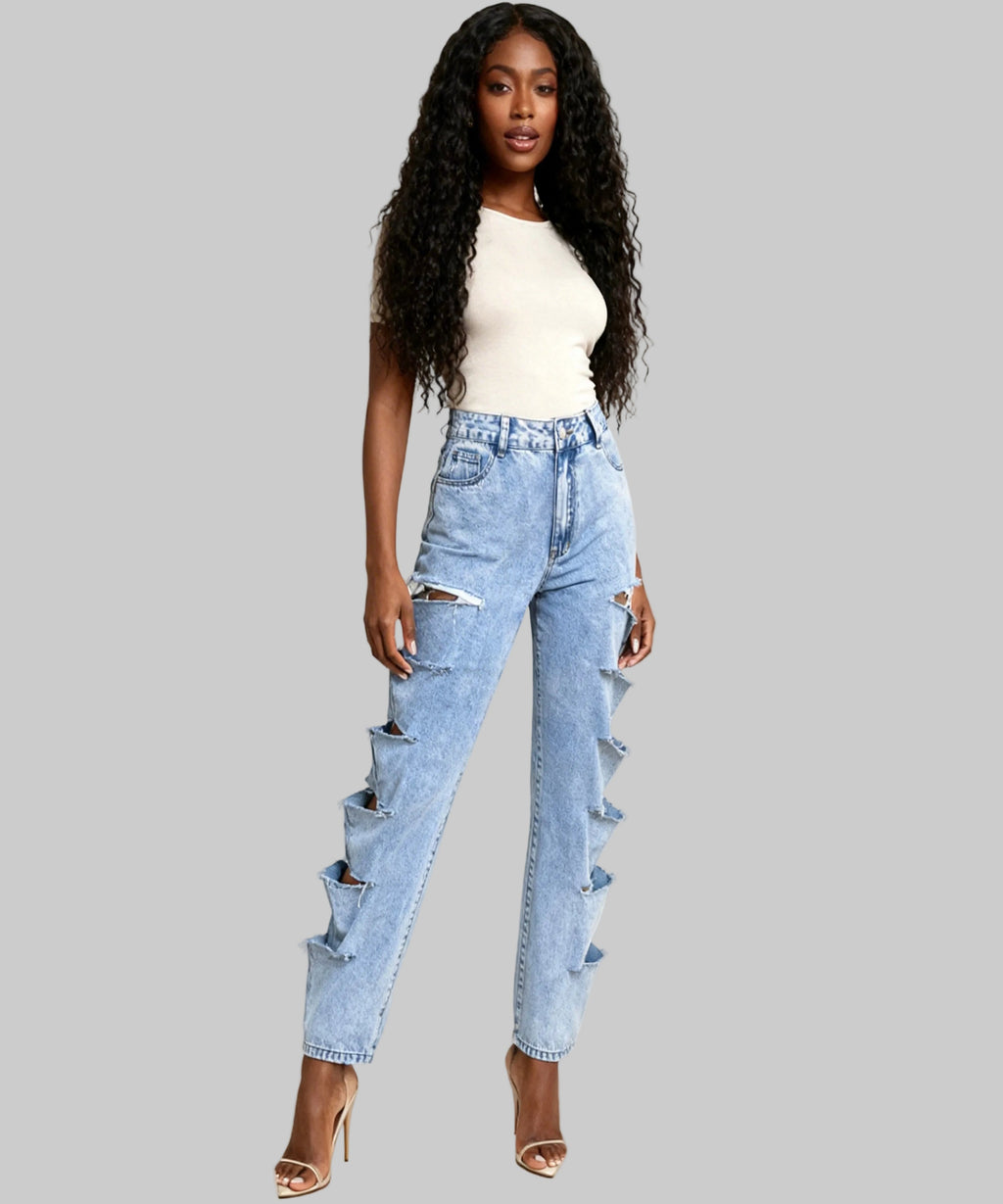 Woman wearing distressed light blue jeans on a white background