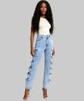 Woman wearing distressed light blue jeans on a white background