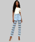Woman wearing light blue jeans with a patterned design on a white background