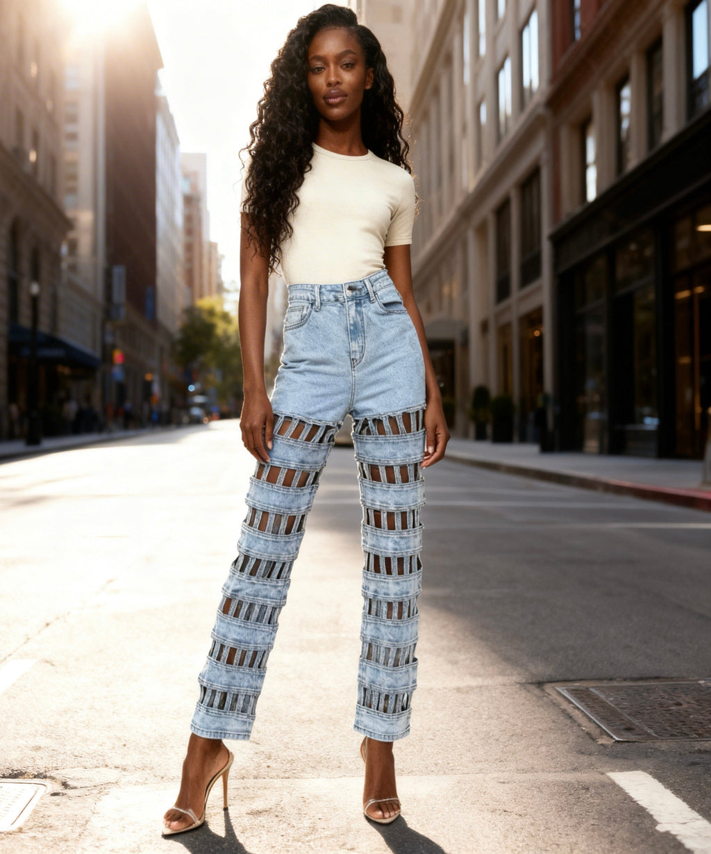 Woman wearing light blue jeans with a patterned design on a city street.