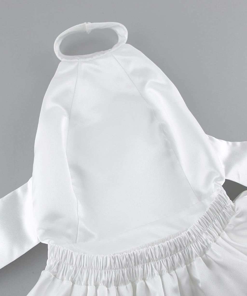 White dress with a fitted bodice and flowing skirt on a gray background