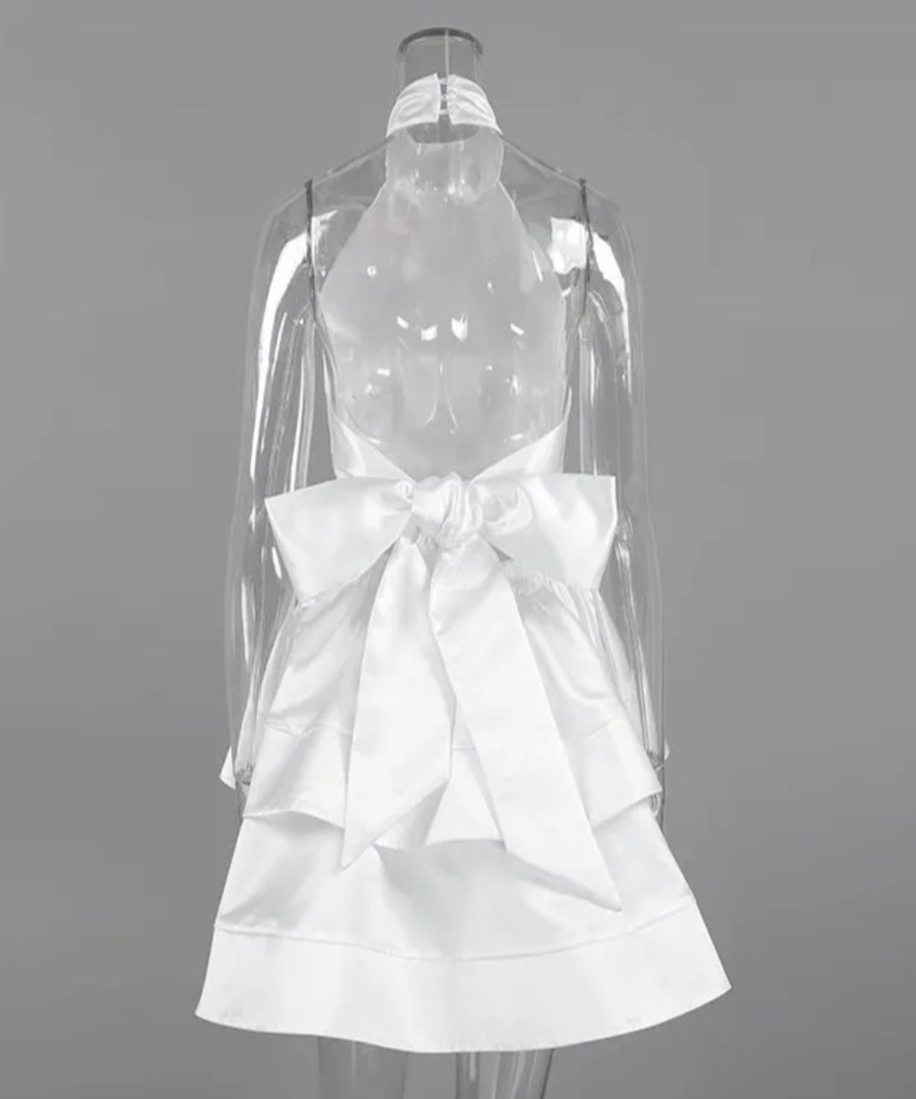 White dress with a large bow on a mannequin against a gray background