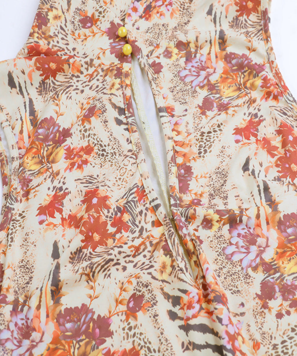 Floral and animal print fabric with buttons on a white background