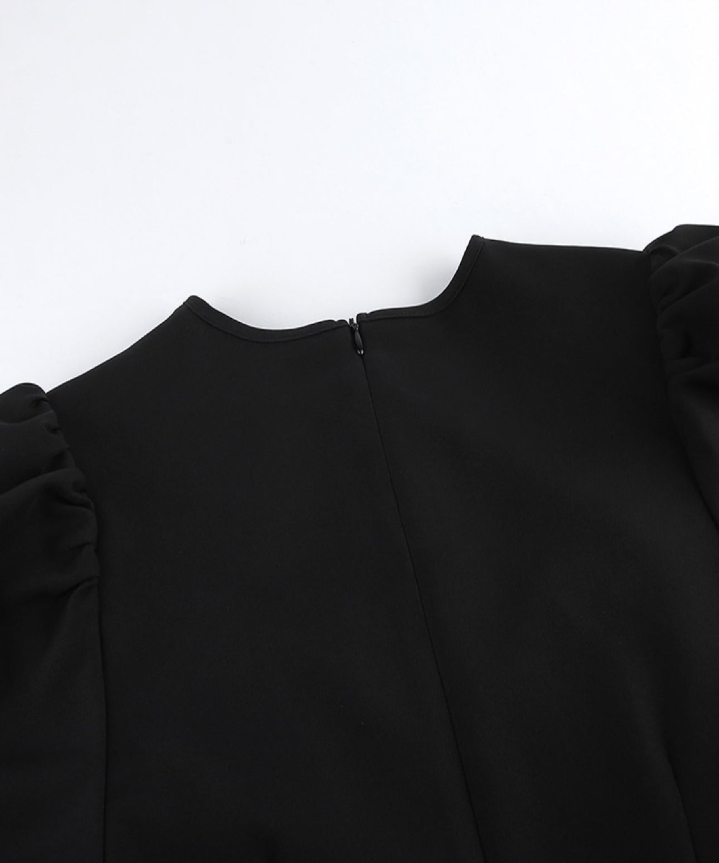 Black blouse with puffed sleeves on a white background