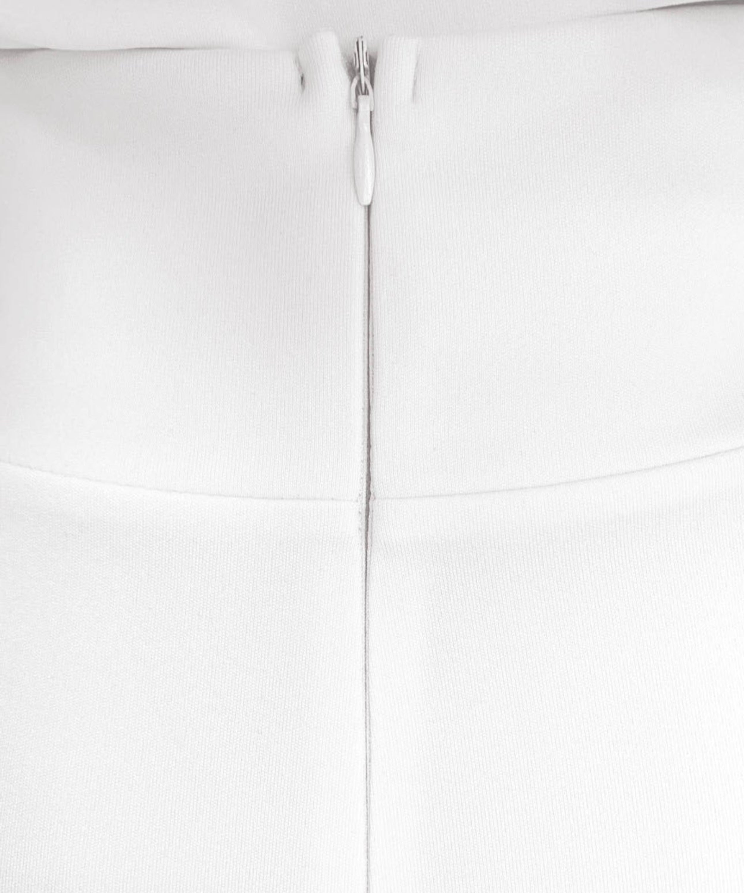 Close-up of a white zipper on a white background